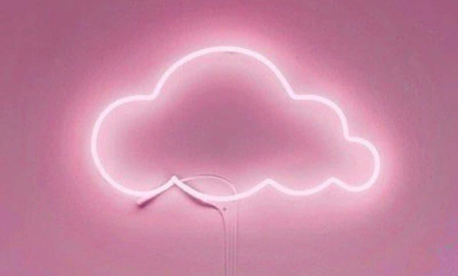 凝視雲朵的寧靜之美 壁紙 — 一個發光的白色霓虹雲牌在相配的粉紅色牆壁上投射出柔和的粉紅色光暈。