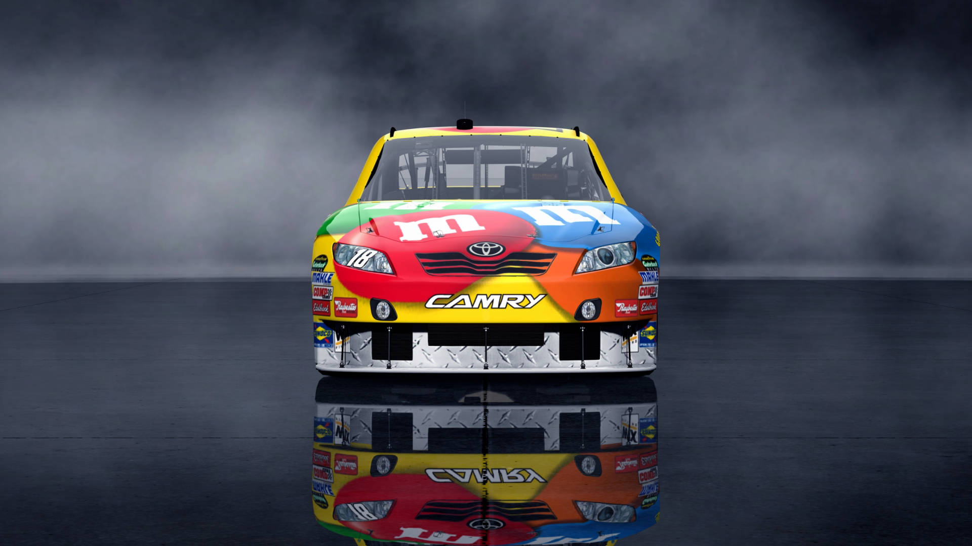 凱爾·布希的M&M's賽車 壁紙 — 一輛色彩繽紛的M&M's主題豐田Camry賽車，帶有彩色糖果殼圖案，站在反射性深色地板上，背景有煙霧。