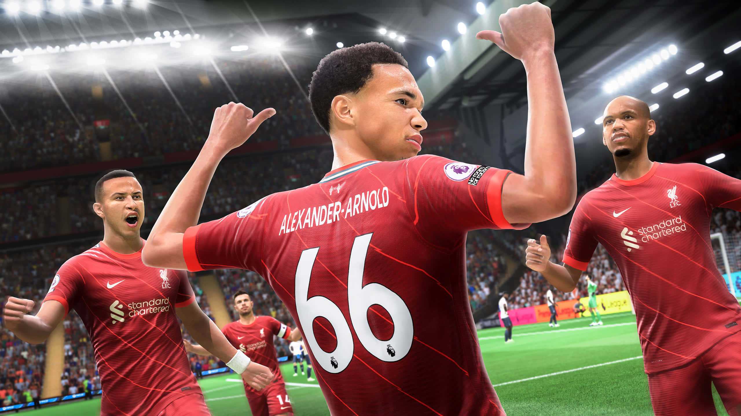 Fifa 22 桌布 壁紙 — 利物浦足球員身穿紅色球衣，在明亮的球場燈光下慶祝入球，背景有歡呼的球迷。