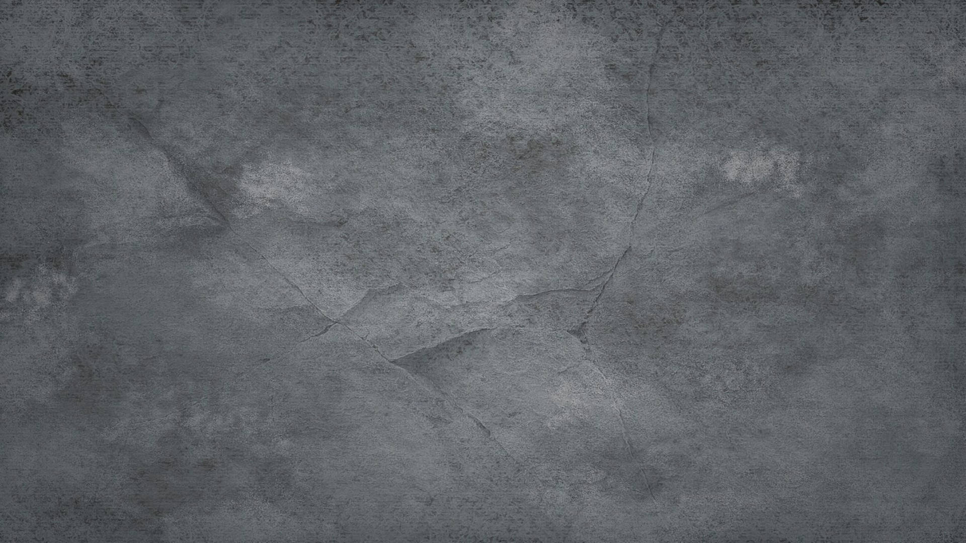 風化灰色混凝土牆，帶有可見裂縫和紋理。