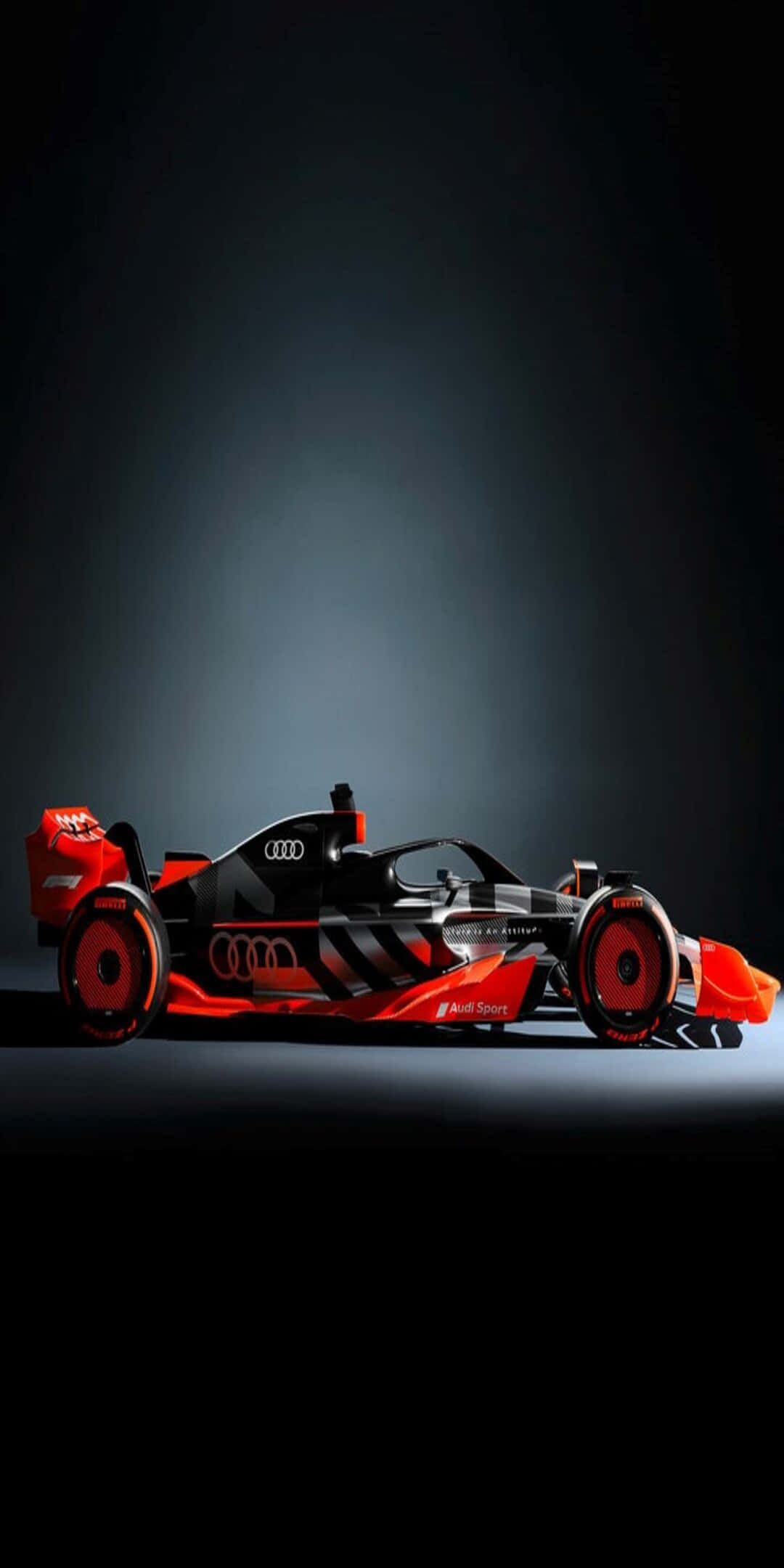 刺激速度 – Pixel 3 2016 F1 賽車壁紙 壁紙 — 一輛時尚的黑色和紅色 Audi Formula E 賽車，在黑暗的攝影棚背景下被聚光燈照亮。