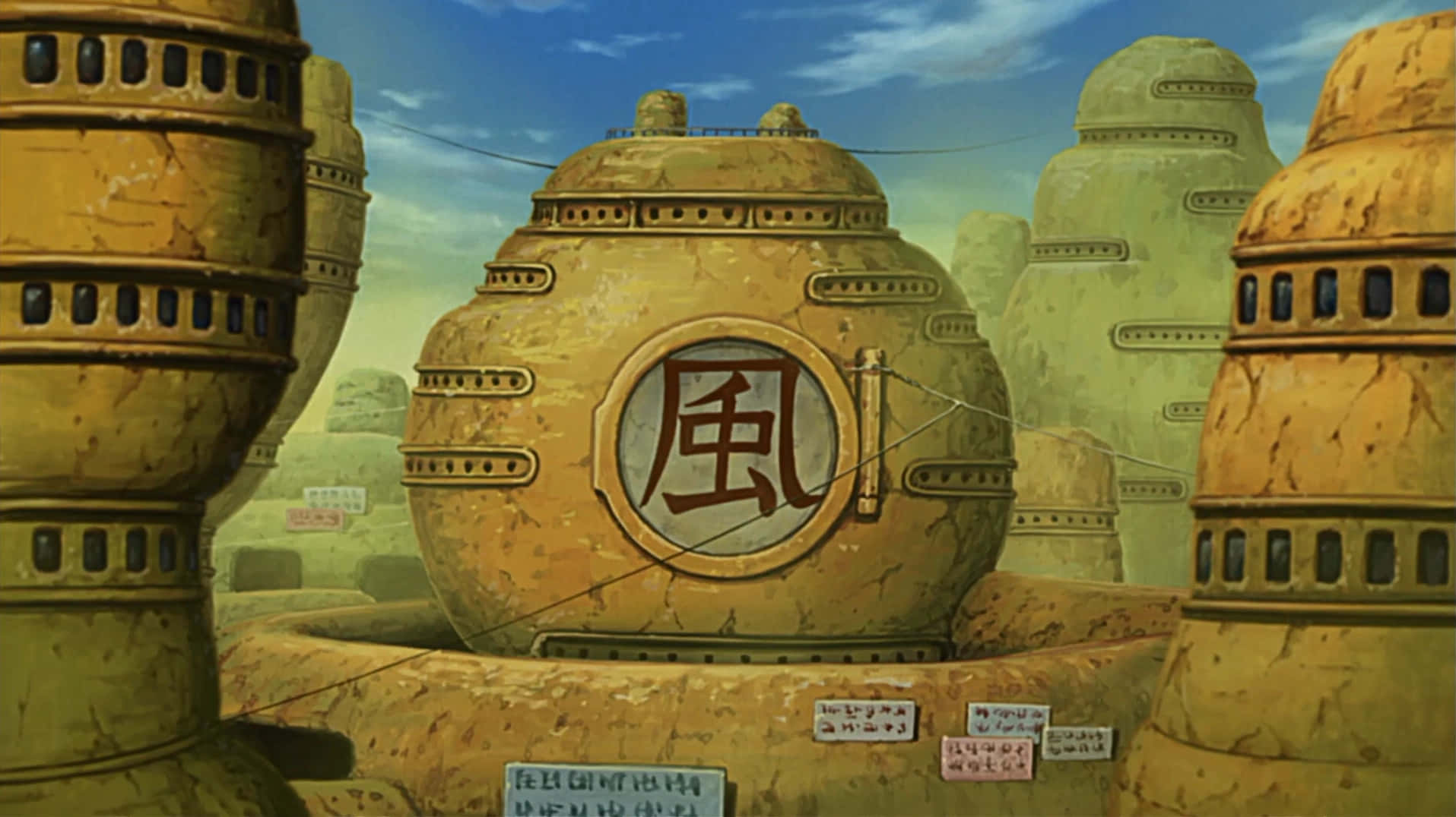 Hidden Sand Village 桌布 壁紙 — 刻有漢字的古老石塔矗立在沙漠景觀中，上方是明亮的藍天。