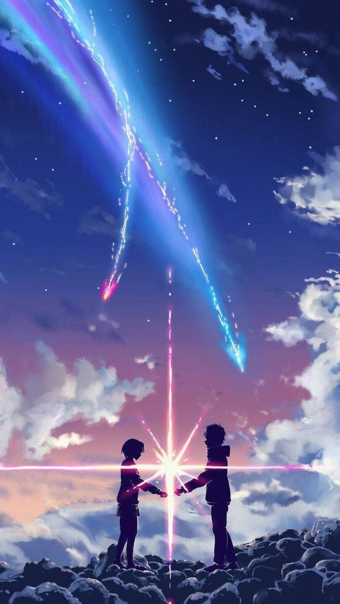 山頂上的兩個人在星光燦爛的夜空下，在發光的宇宙光束下握手。