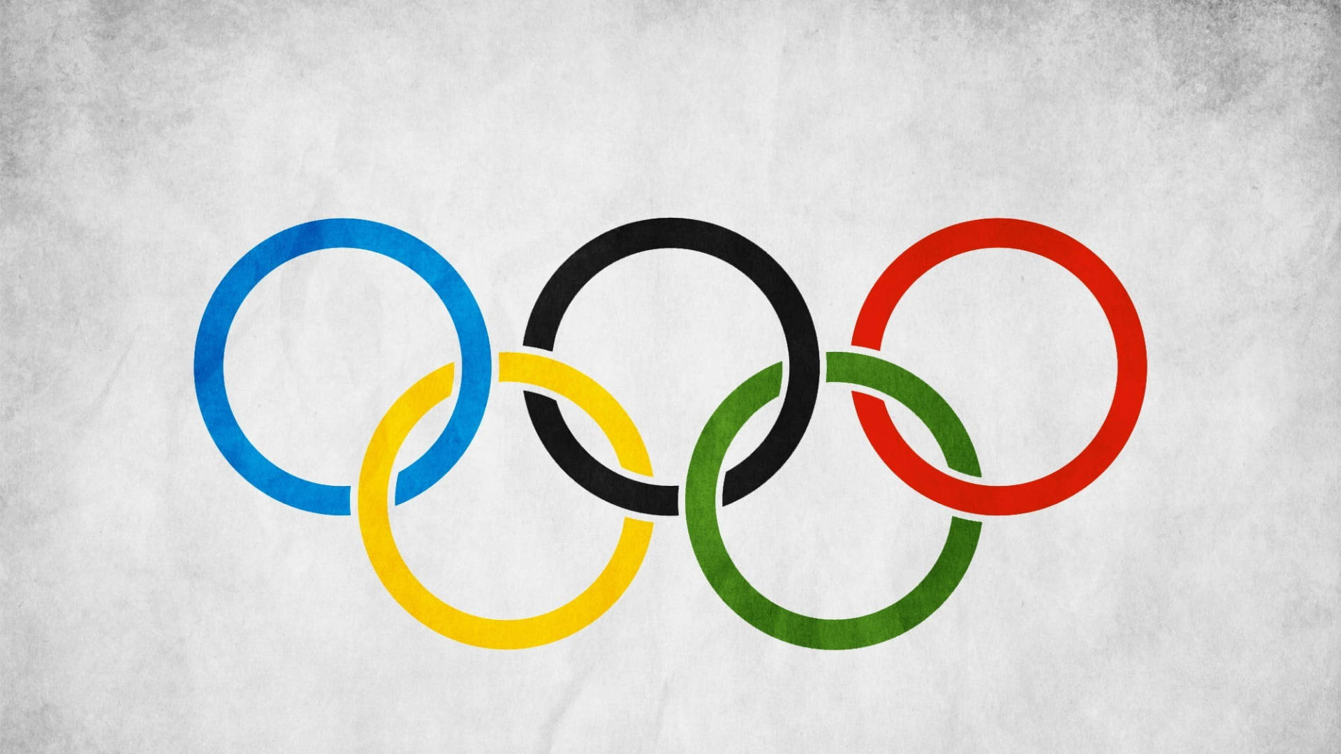 五個奧運環，象徵全球體育團結，位於有紋理的灰色背景上。