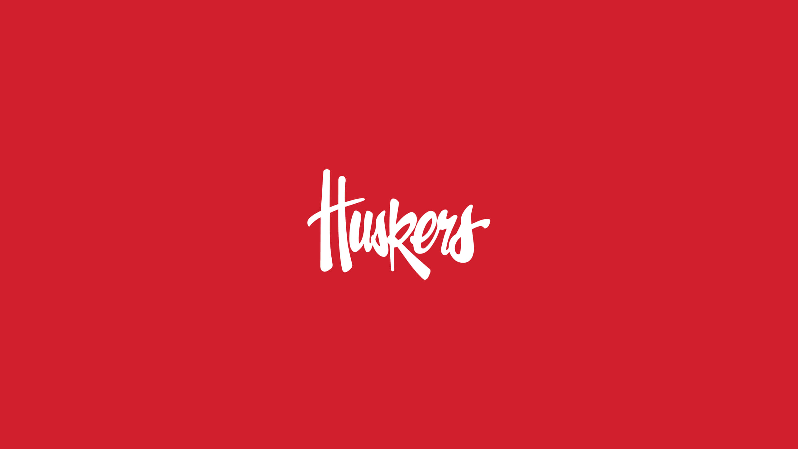 加油！大紅隊！ 壁紙 — 粗體白色草書Huskers標誌居中於純深紅色背景上。