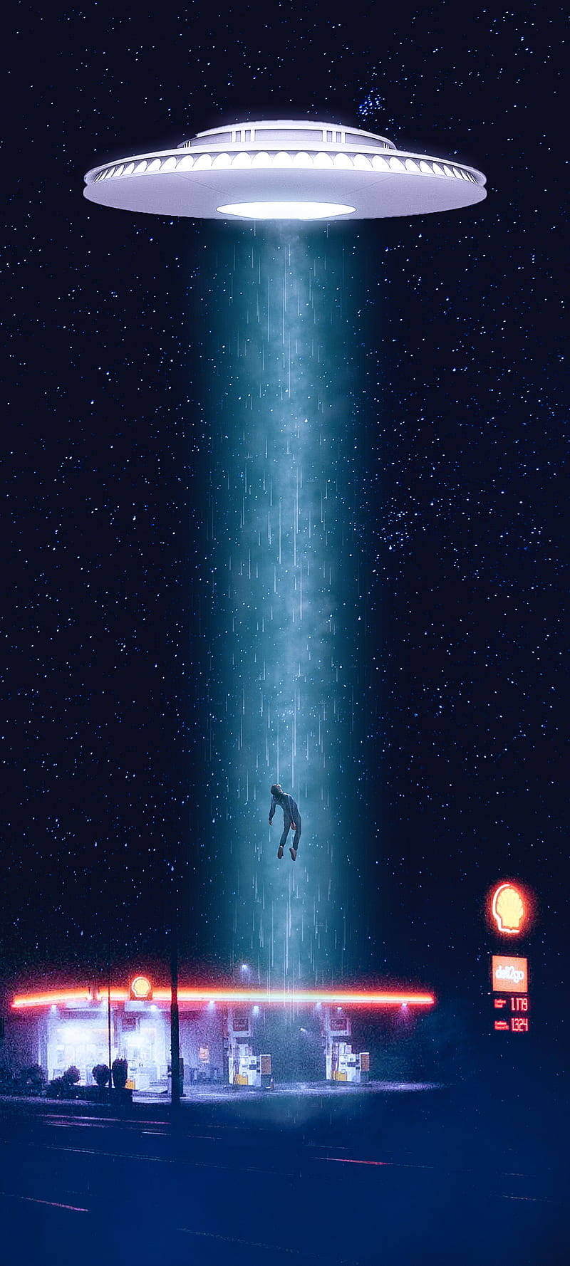 一個人在夜間被UFO光束從發光的加油站上方吊起。