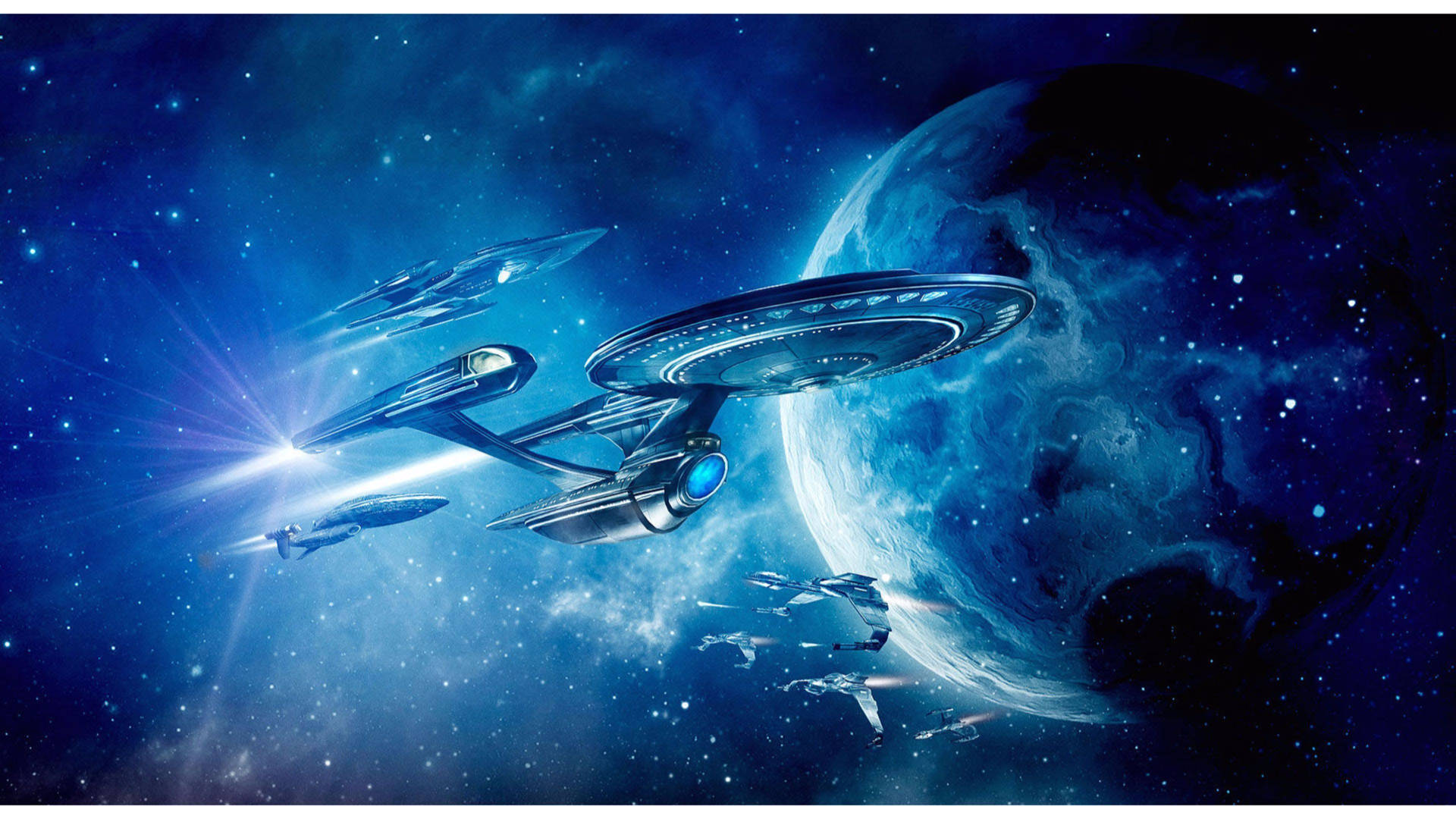 星際艦隊的船隻在深空中靠近一顆氣態巨行星的藍色星雲中航行。 — 星際迷航 壁紙