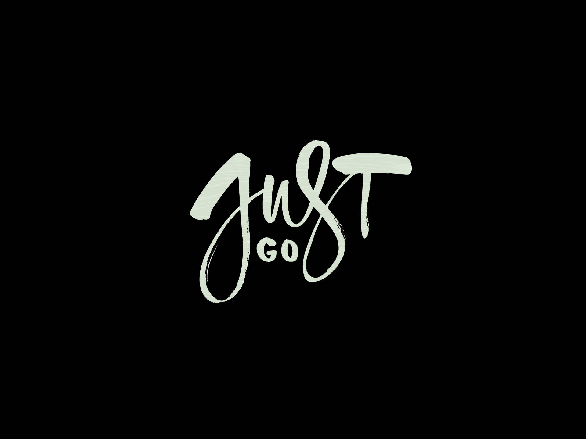 黑色背景上白色刷字體書寫的勵志短語just go