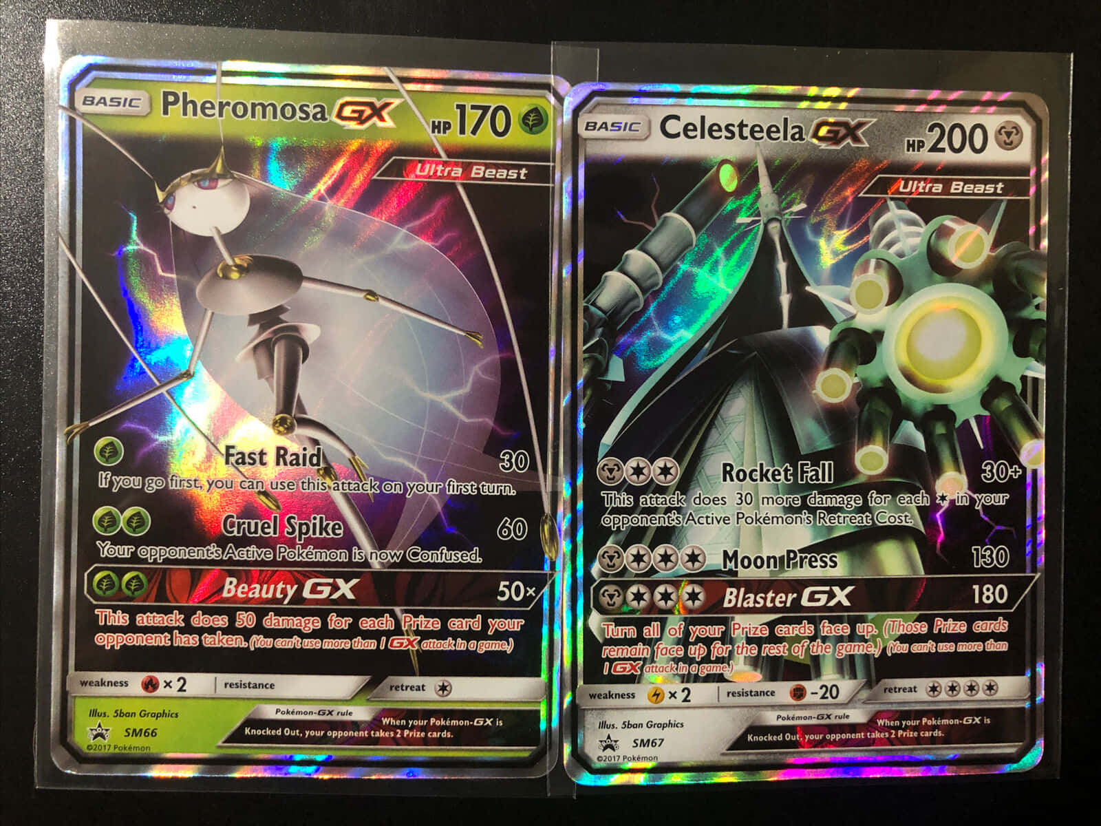 動感Pheromosa與Celesteela收藏卡 壁紙 — 兩張閃亮的寶可夢GX卡， featuring Pheromosa GX 和 Celesteela GX，帶有全息彩虹背景。