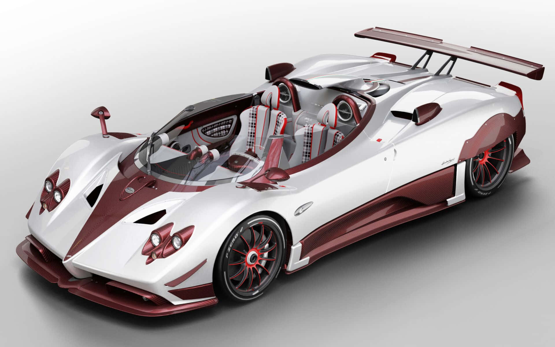 動感非凡的帕加尼Zonda HP Barchetta 壁紙 — 一輛時尚的白色和栗色帕加尼Zonda跑車，帶有大型後尾翼和裸露的碳纖維細節。