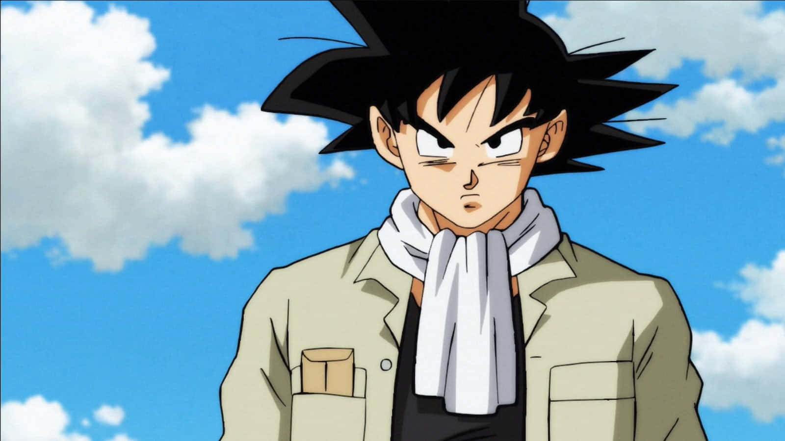 Dragon Ball Super Universe 6 桌布 壁紙 — 動漫角色悟空以兇猛的表情站在明亮的藍天和蓬鬆的白雲前。