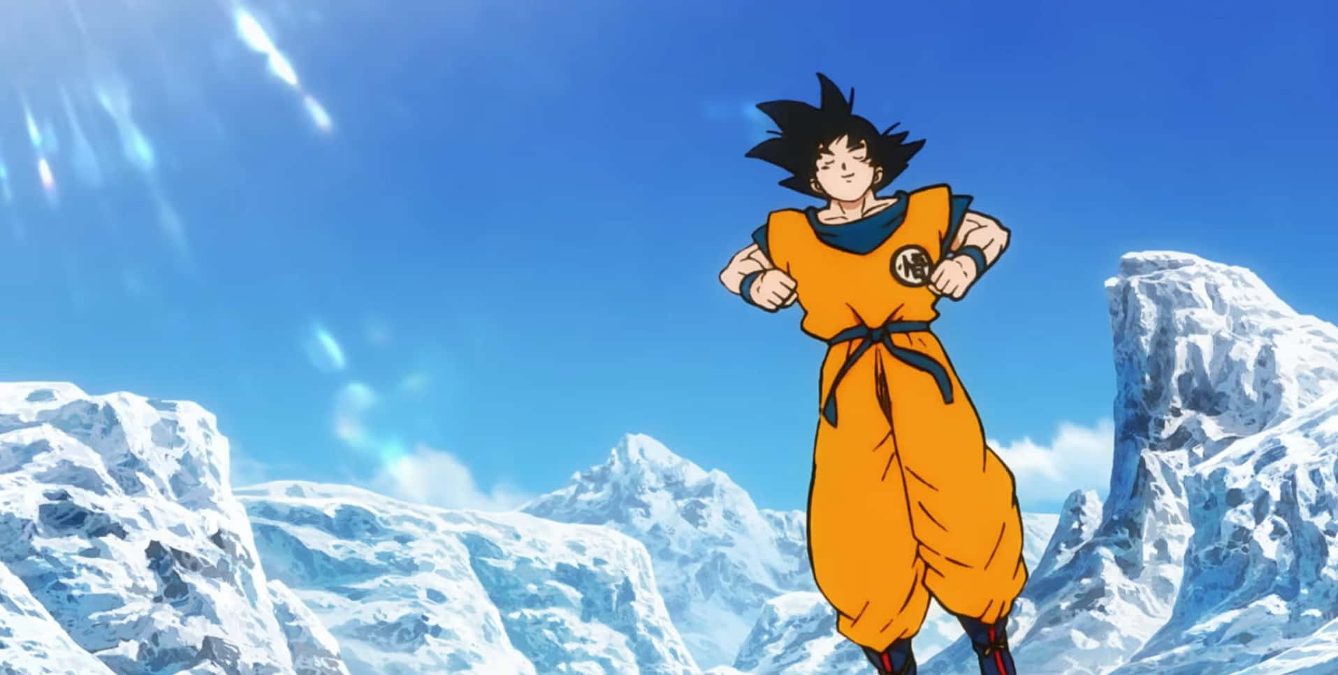 Dragon Ball Movies 桌布 壁紙 — 動漫角色悟空自信地站在雪覆蓋的山景中，背景是明亮的藍天和陽光。