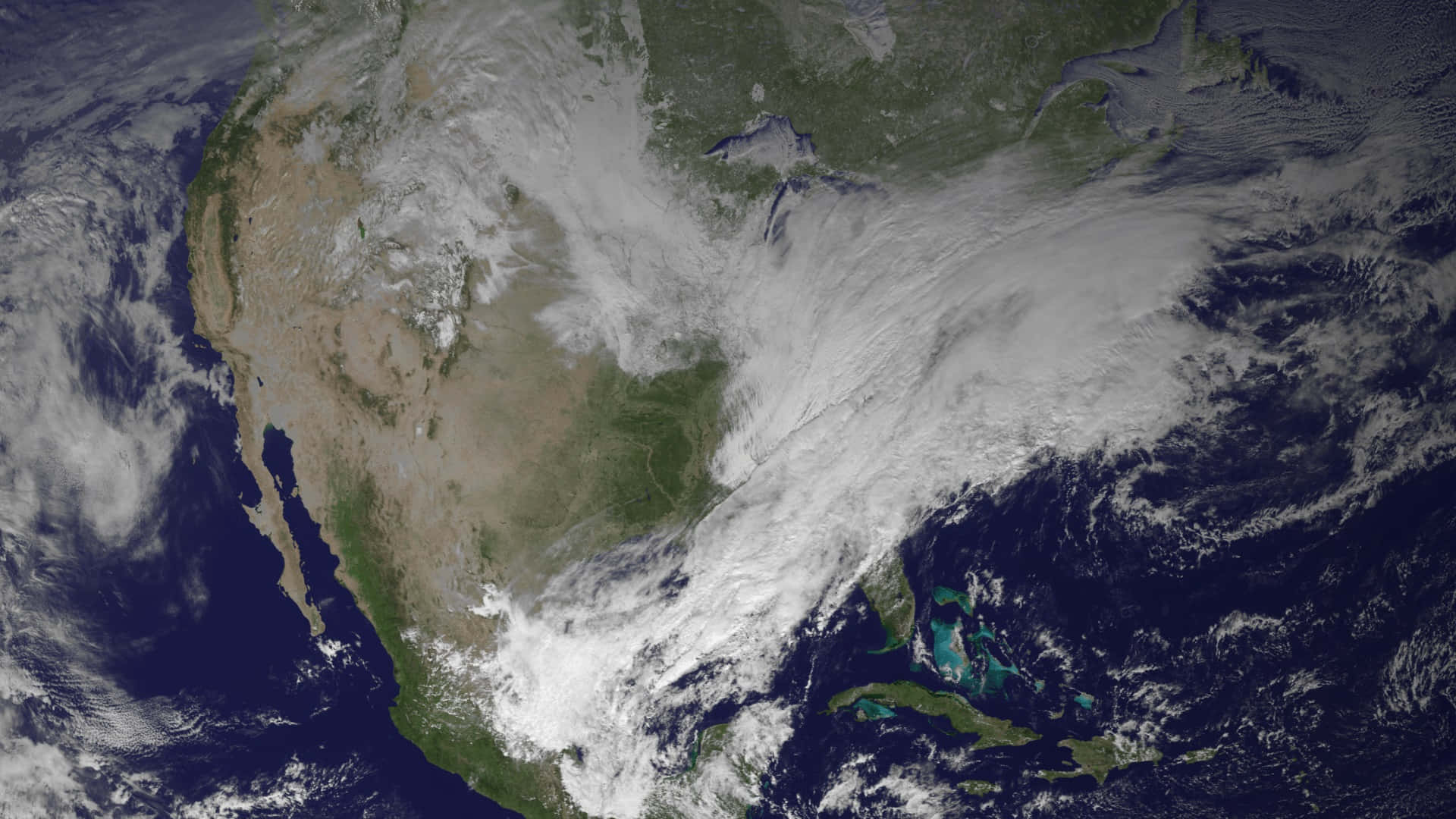 Polar Vortex 桌布 壁紙 — 北美大陸及周邊海洋上空有旋轉風暴雲層的衛星視圖。