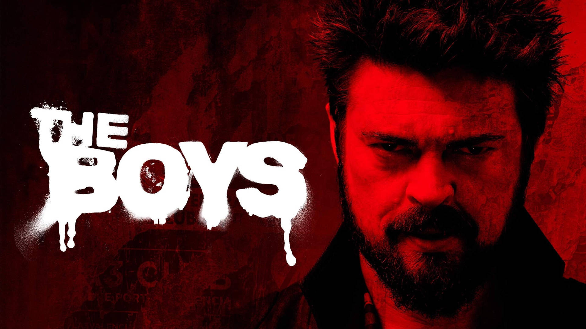 一個留鬍鬚的男人，在紅色背景前有「THE BOYS」文字，眼神強烈。 — 男生 壁紙