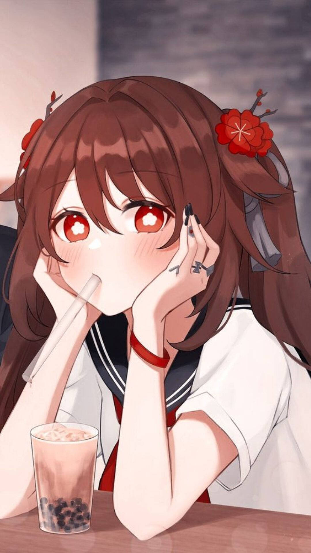 紅眼睛的動漫女孩在桌上喝珍珠奶茶。