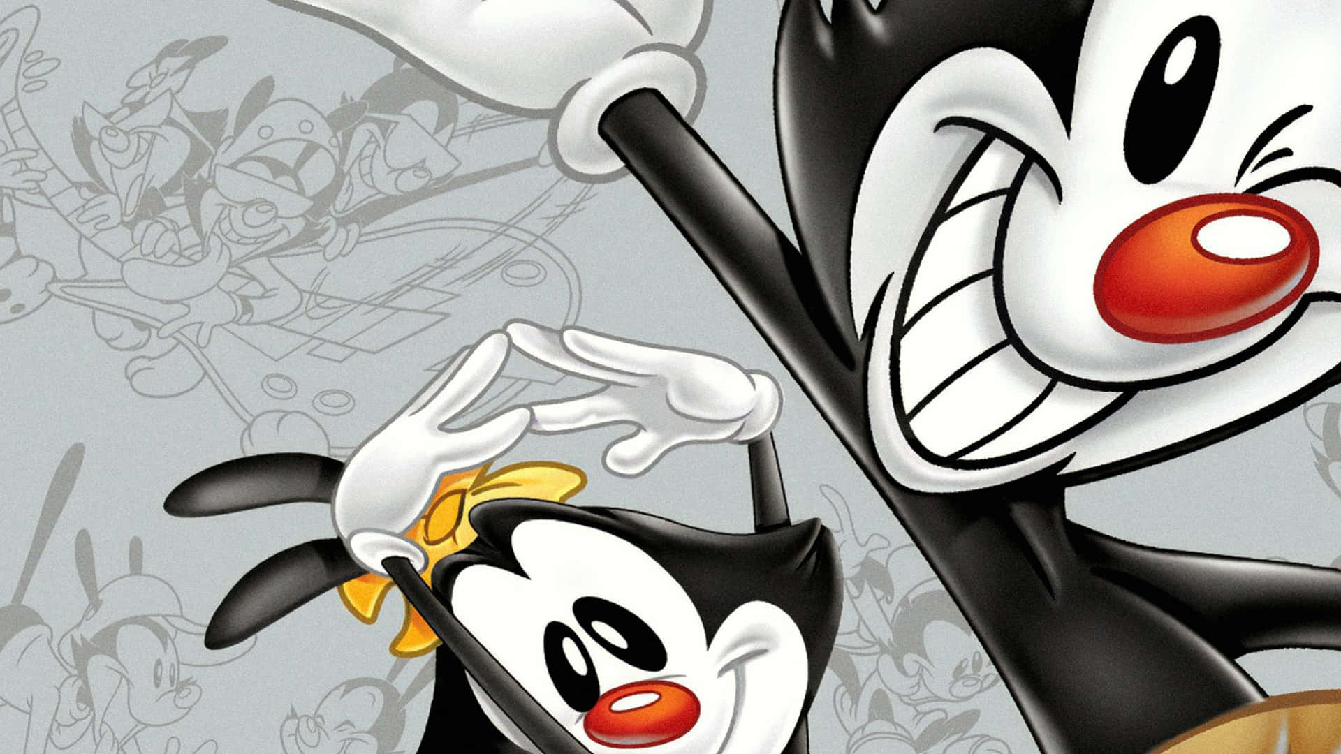 卡通混亂 —— Wakko、Yakko 與 Dot 奪取世界 壁紙 — 兩隻黑白卡通企鵝，紅色喙，在充滿模糊角色草圖的灰色背景前愉快地擺姿勢。