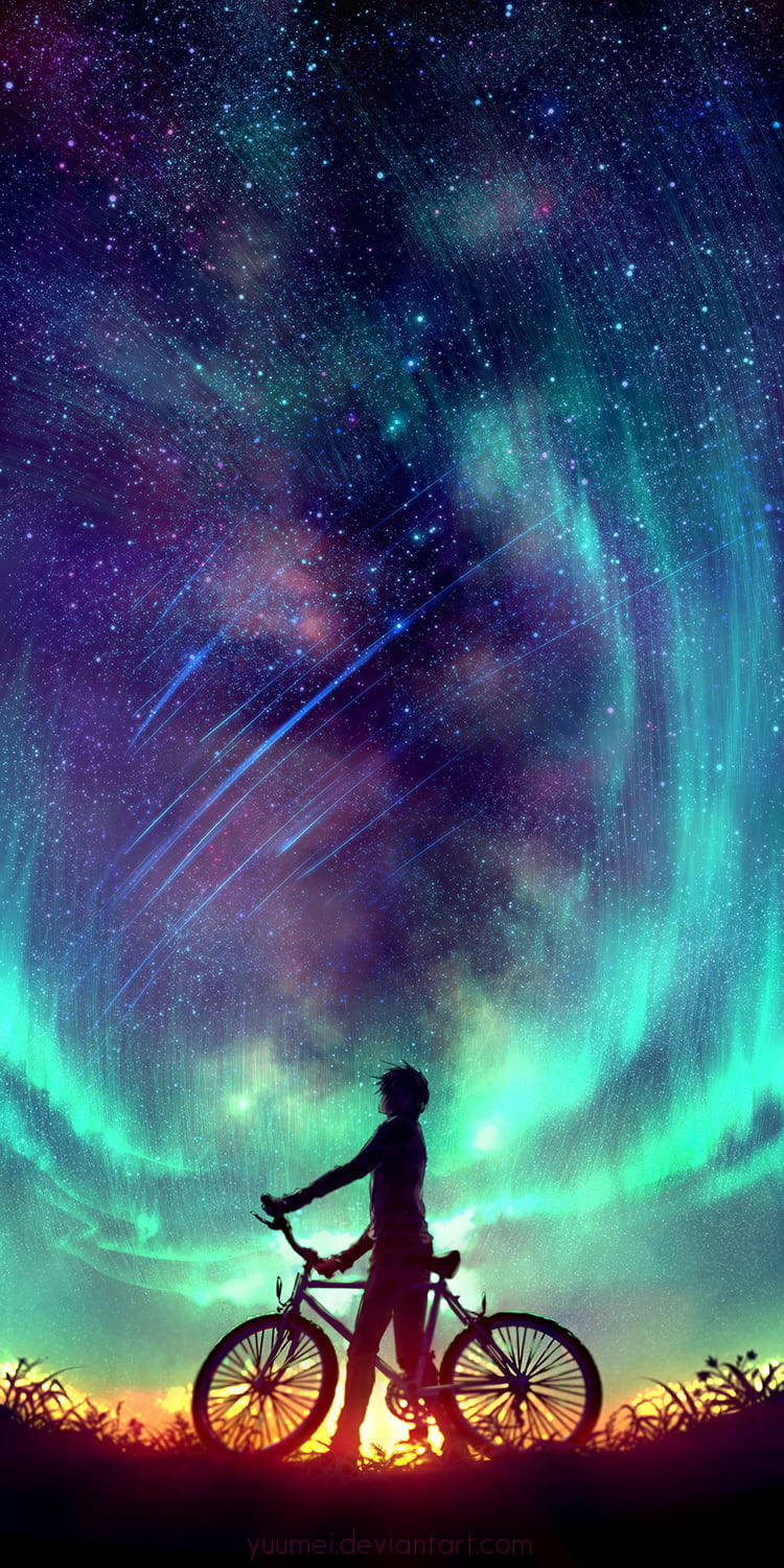 一個人在充滿活力的星空極光下與單車的剪影。
