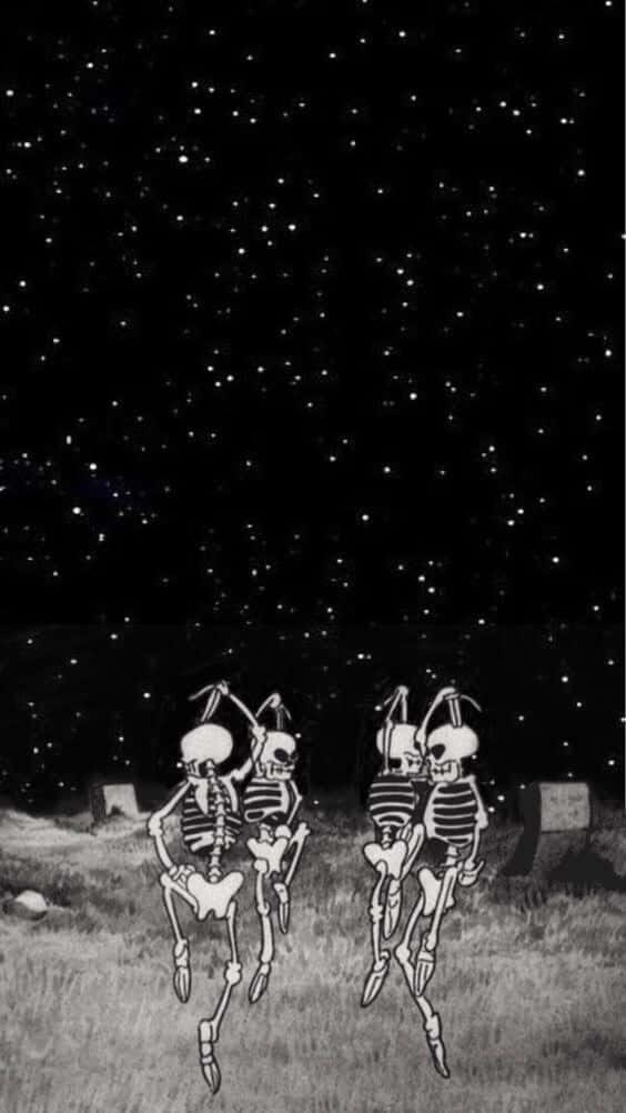 兩個骷髏在星空下的墓園裡跳舞。