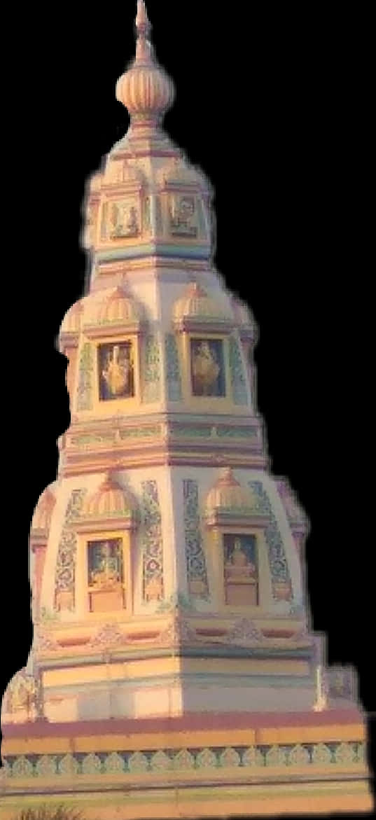 印度教廟宇Shikhara建築細節.JPG 壁紙 — 一座高聳華麗的寺廟塔樓，帶有精緻的雕刻和雕像，沐浴在溫暖的金色光芒中，背景為黑色。