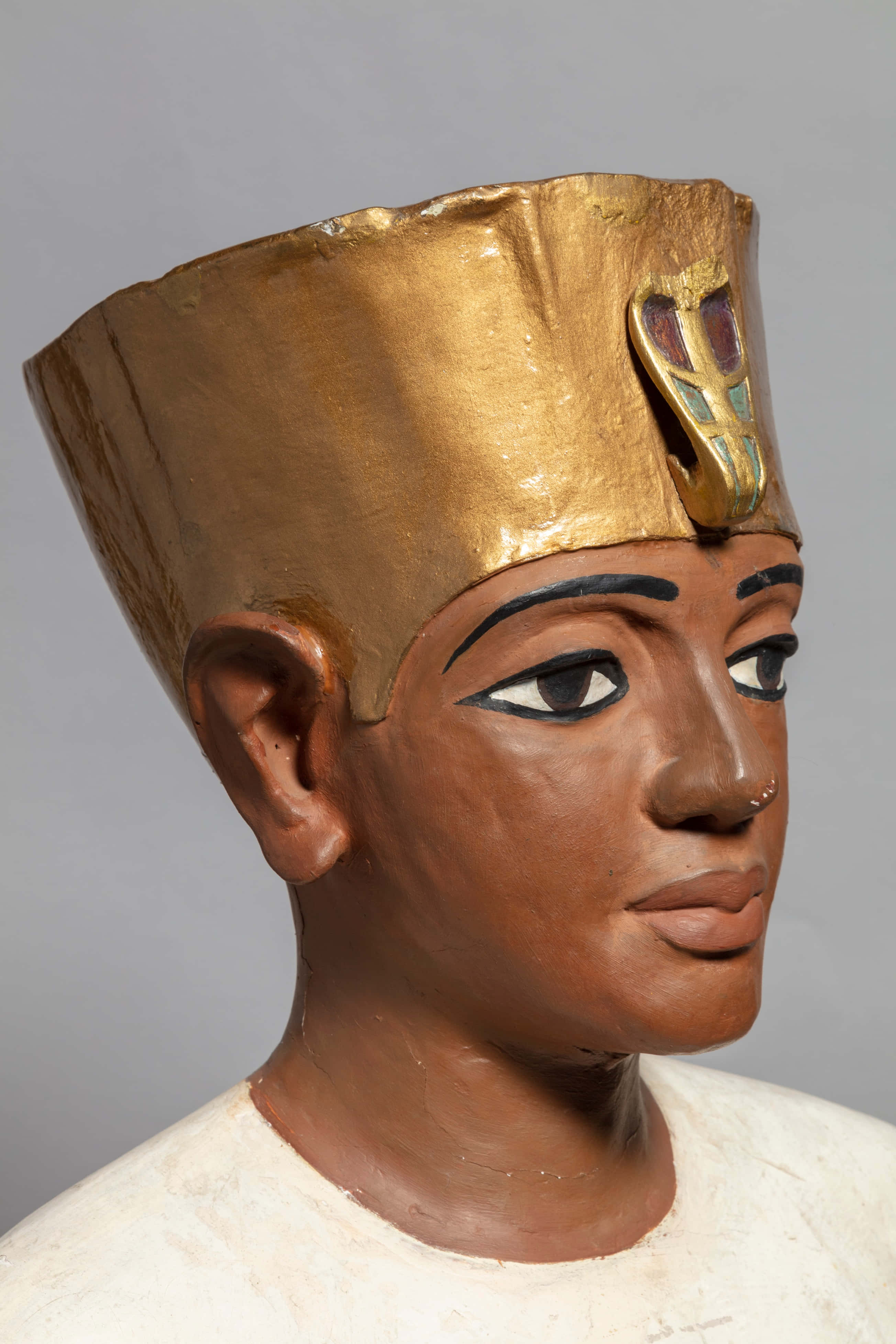 Ancient Egypt 桌布 壁紙 — 古埃及彩繪木製雕像頭部特寫，帶有金色王冠和鑲嵌眼睛，背景為中性灰色。