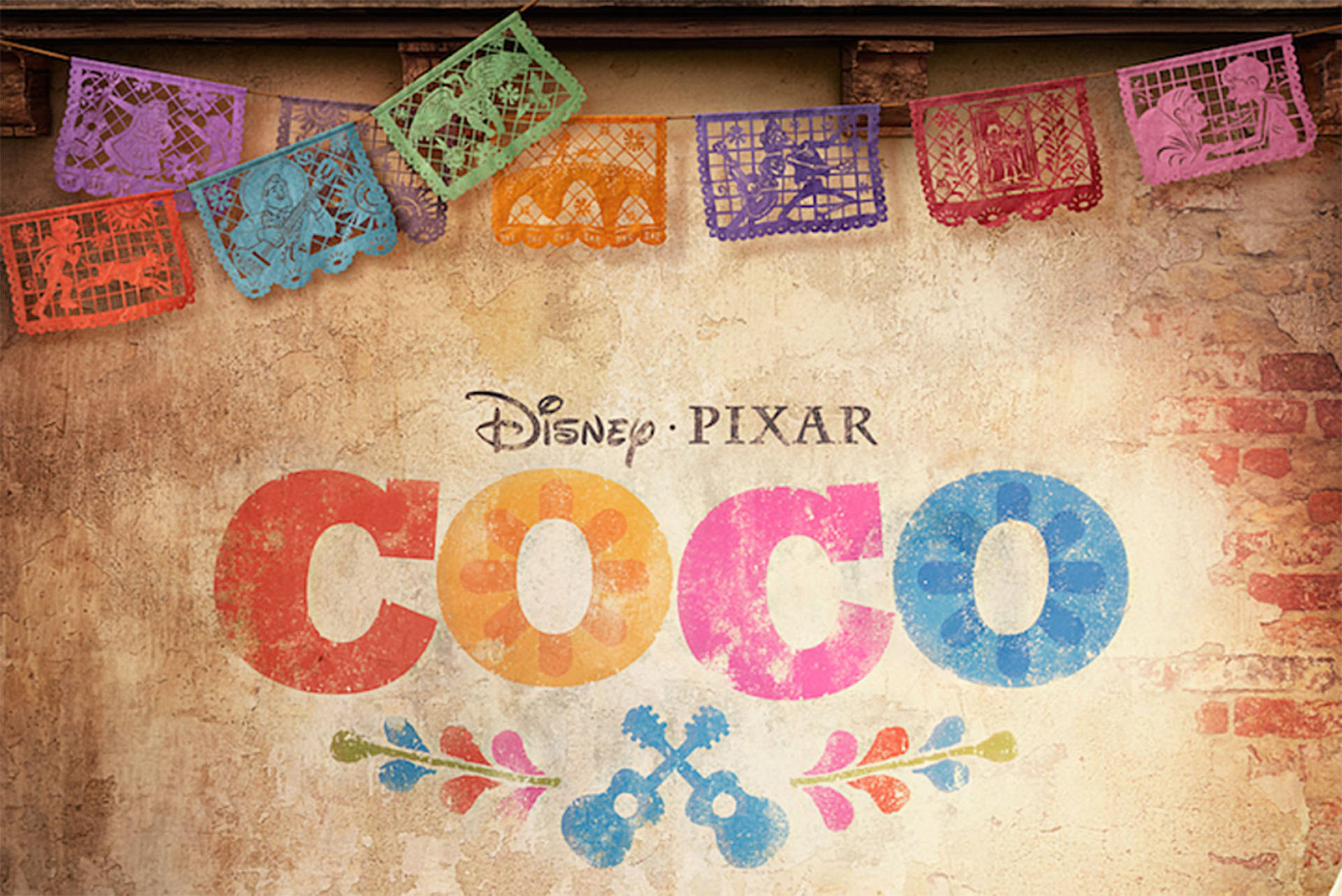 Coco 電影標題與 papel picado 橫幅在質樸的牆上。