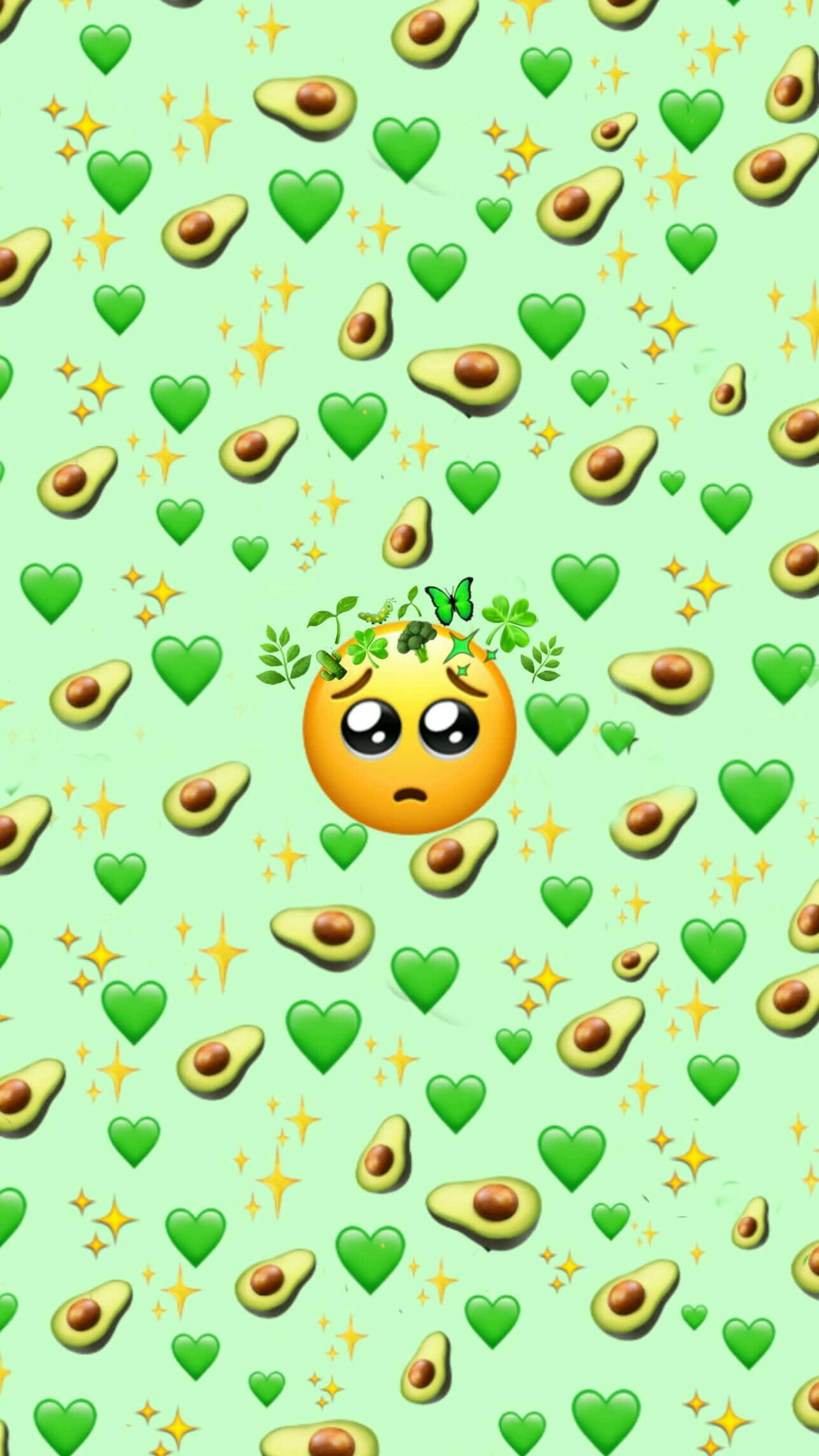 可愛Emoji爆炸背景 壁紙 — 一個悲傷的表情符號戴著綠色葉冠，漂浮在牛油果心形和閃光之間，背景是薄荷色。
