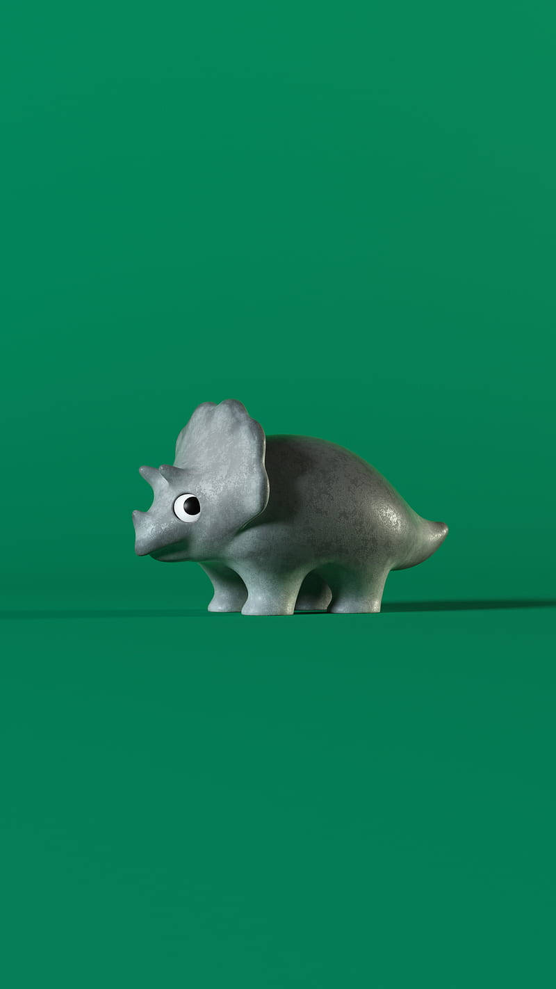 灰色三角龍玩具公仔在綠色背景上