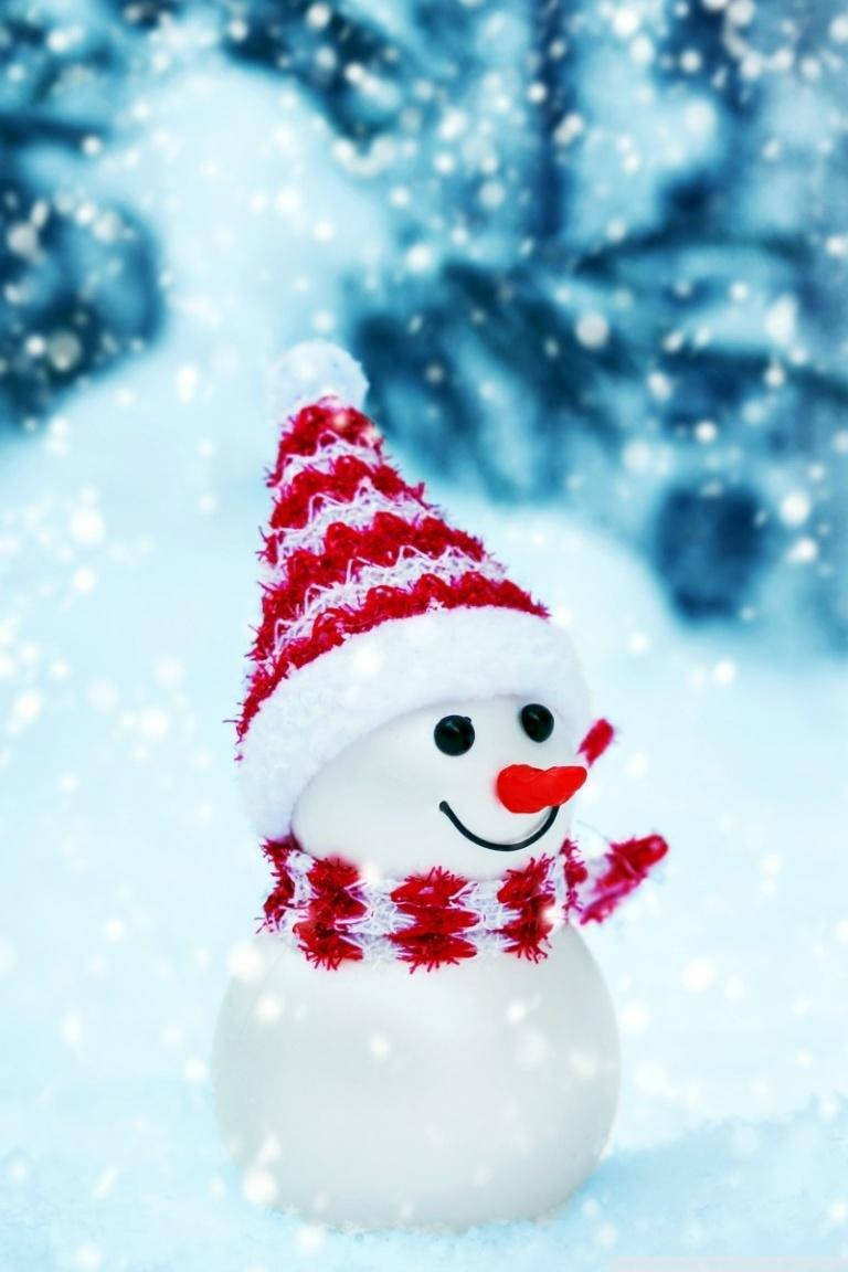 一個戴著紅白帽子和圍巾的微笑雪人，正在下雪。