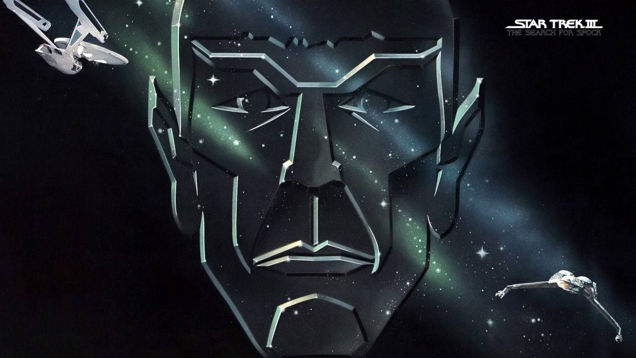 史巴克星際臉孔《星際迷航》 壁紙 — 一個風格化的金屬面孔從星域中浮現，星際飛船在深空中飛過。