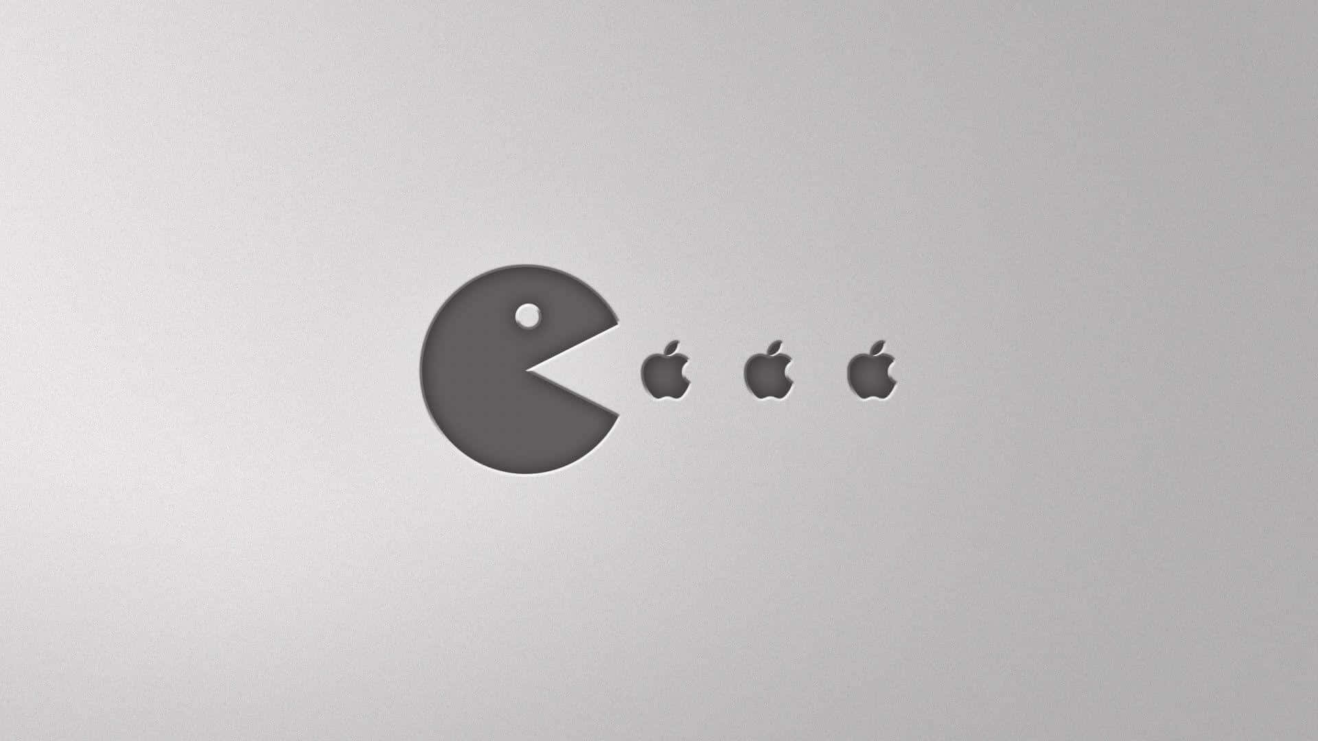 Pac-Man 在銀色表面上吃 Apple 標誌。