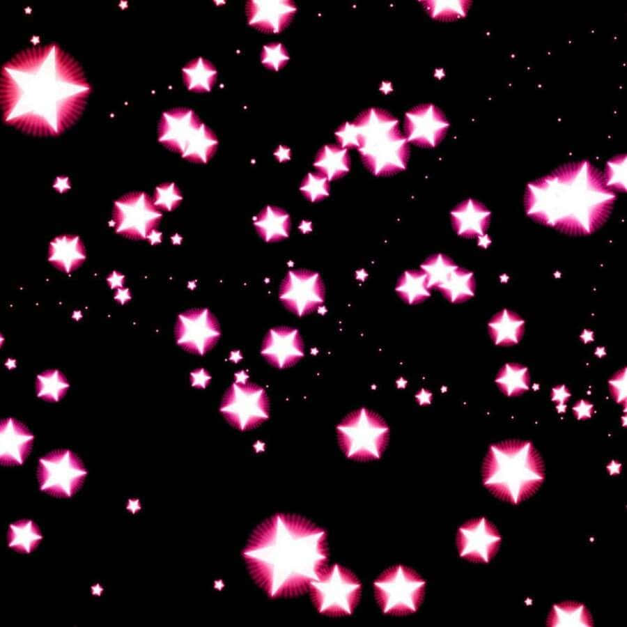 Pink Stars 桌布 壁紙 — 各種大小的鮮豔粉紅色發光星星漂浮在深黑色背景上，營造出閃爍的宇宙效果。