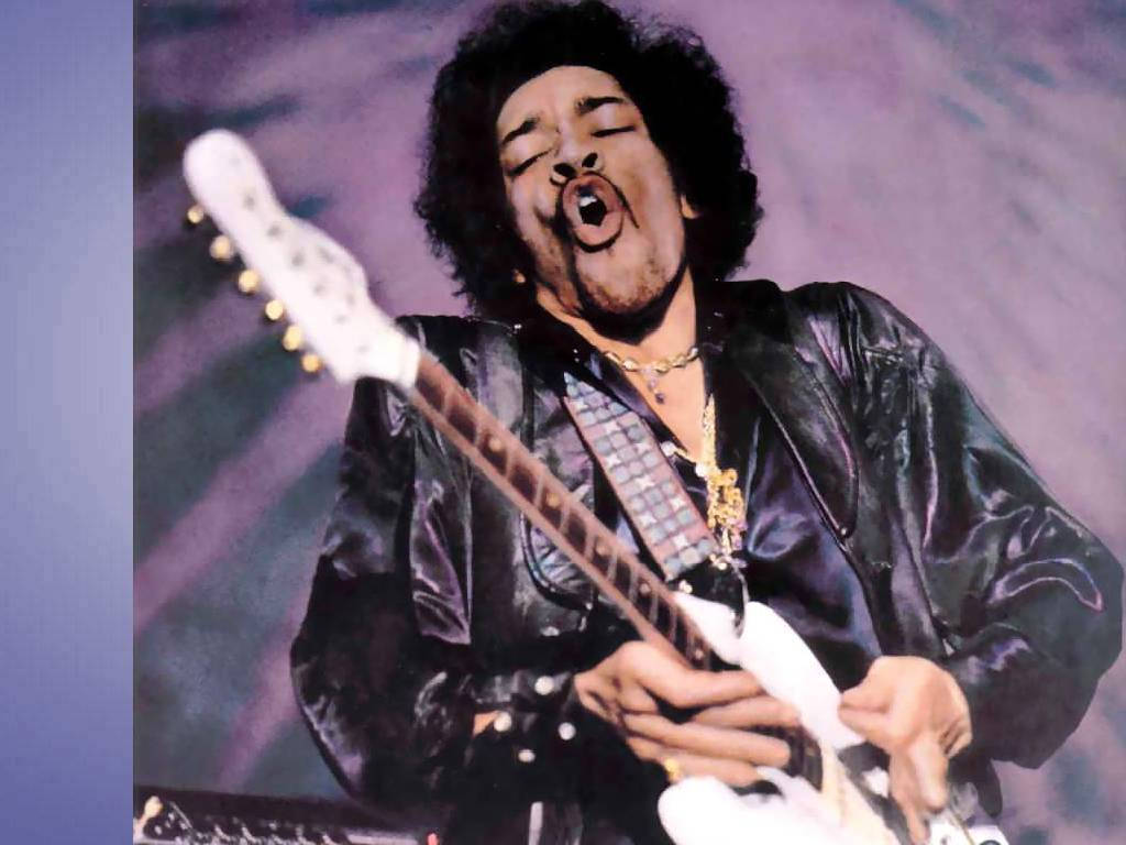 Jimi Hendrix在舞台上閉著眼睛、張開嘴巴彈奏電結他。
