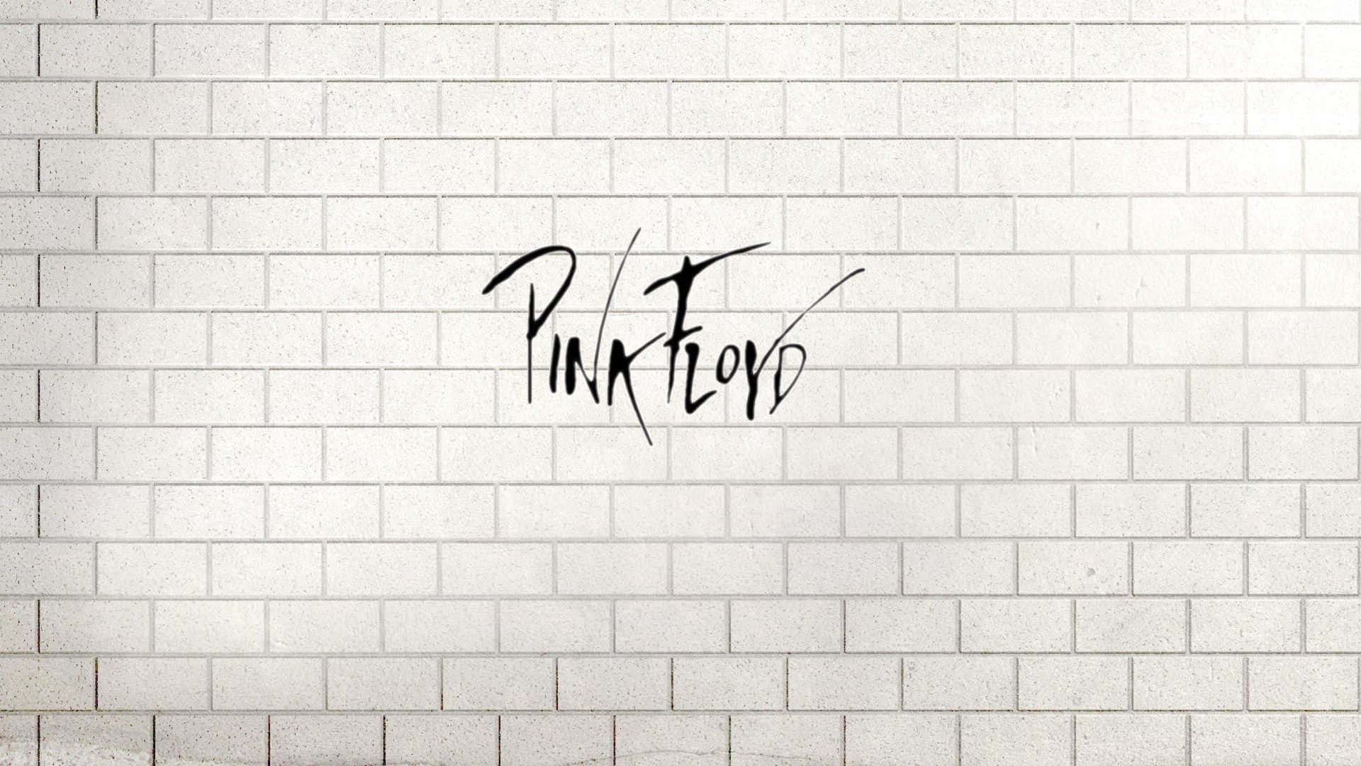 白色磚牆上黑色草書的Pink Floyd標誌。