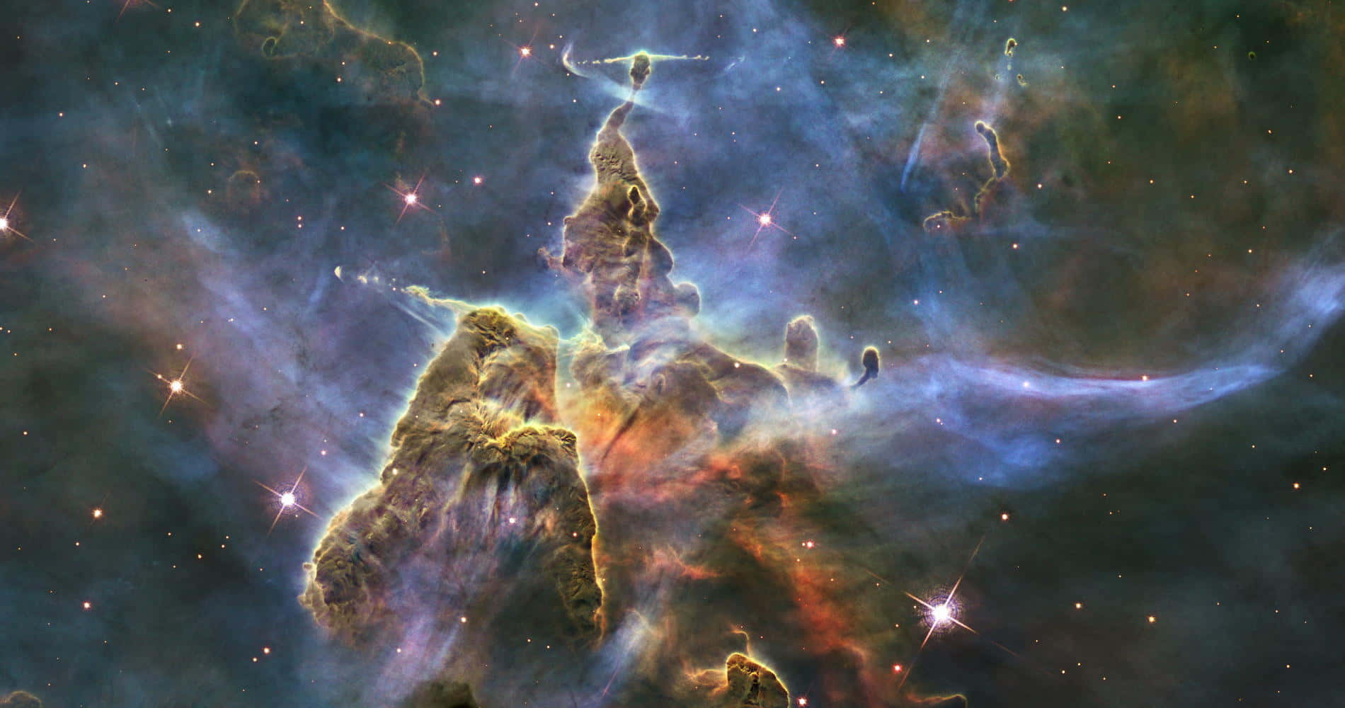 宇宙氣體和塵埃柱，在色彩繽紛的星雲中與新生恆星一起發光。