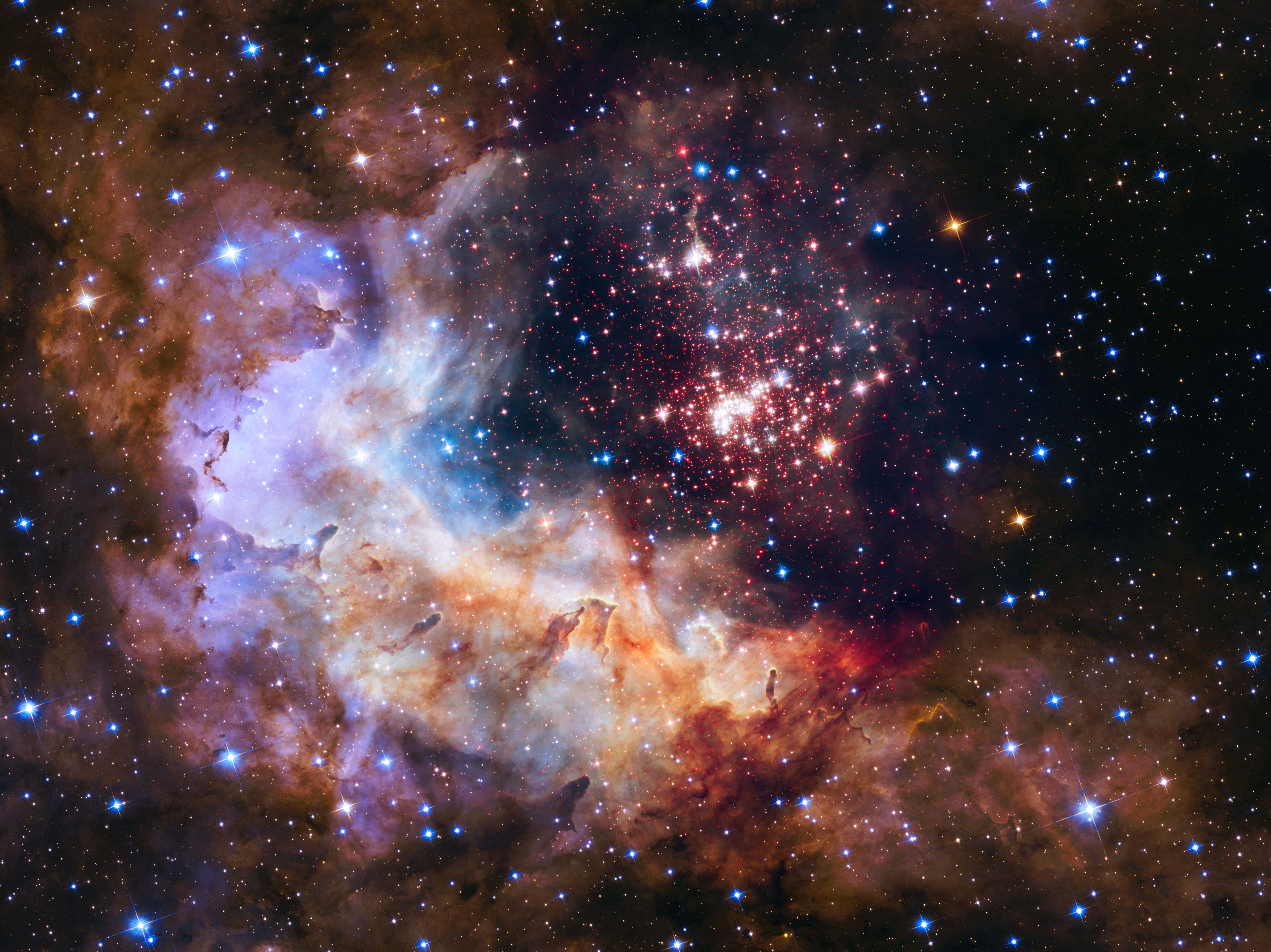 哈勃望遠鏡拍攝的壯觀夜空影像 壁紙 — 一個充滿活力的宇宙星雲，在星空背景下旋轉著發光的紅色、紫色和藍色。