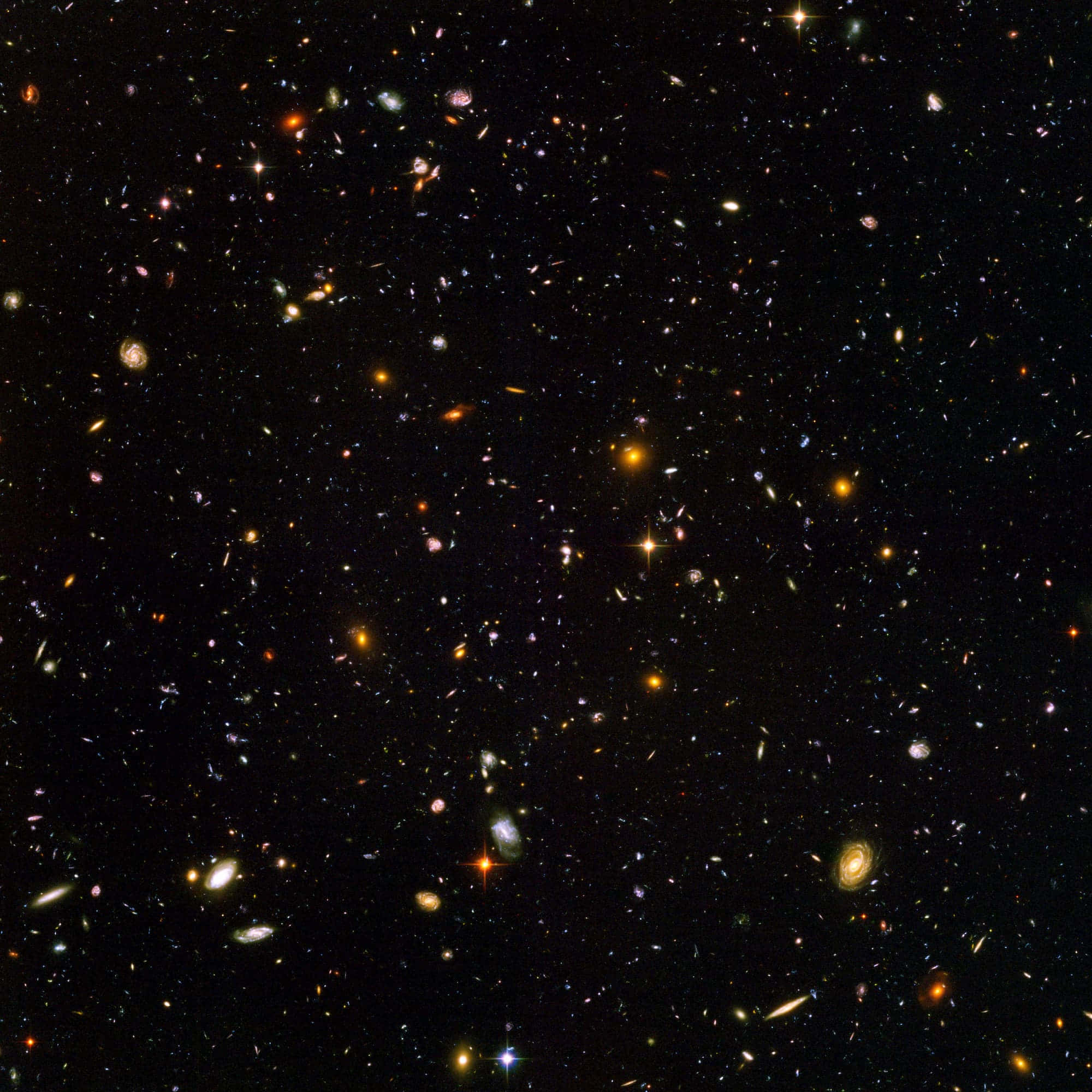 哈勃望遠鏡拍攝的星系與恆星 壁紙 — 令人嘆為觀止的深空景觀，充滿無數星系和恆星，在宇宙虛空中閃耀著鮮豔的色彩。