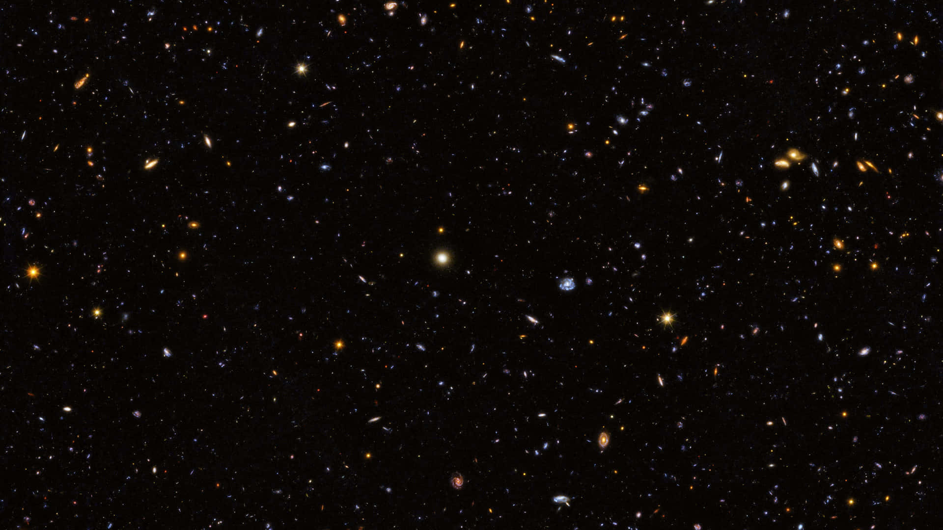 深空充滿遙遠的星系和恆星，背景為黑色。