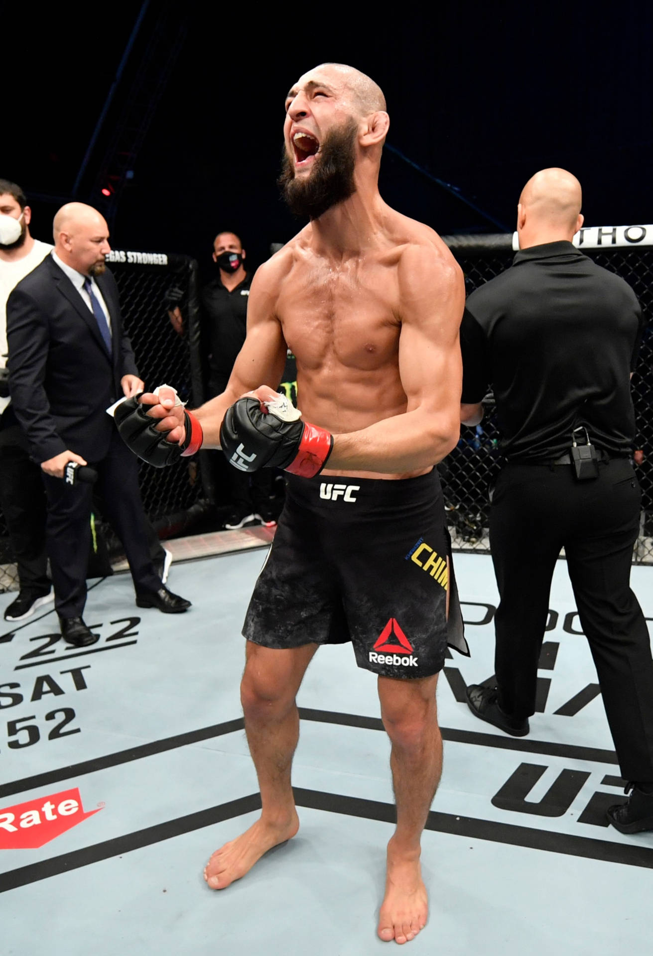 MMA選手在UFC八角籠中高舉雙臂慶祝勝利。