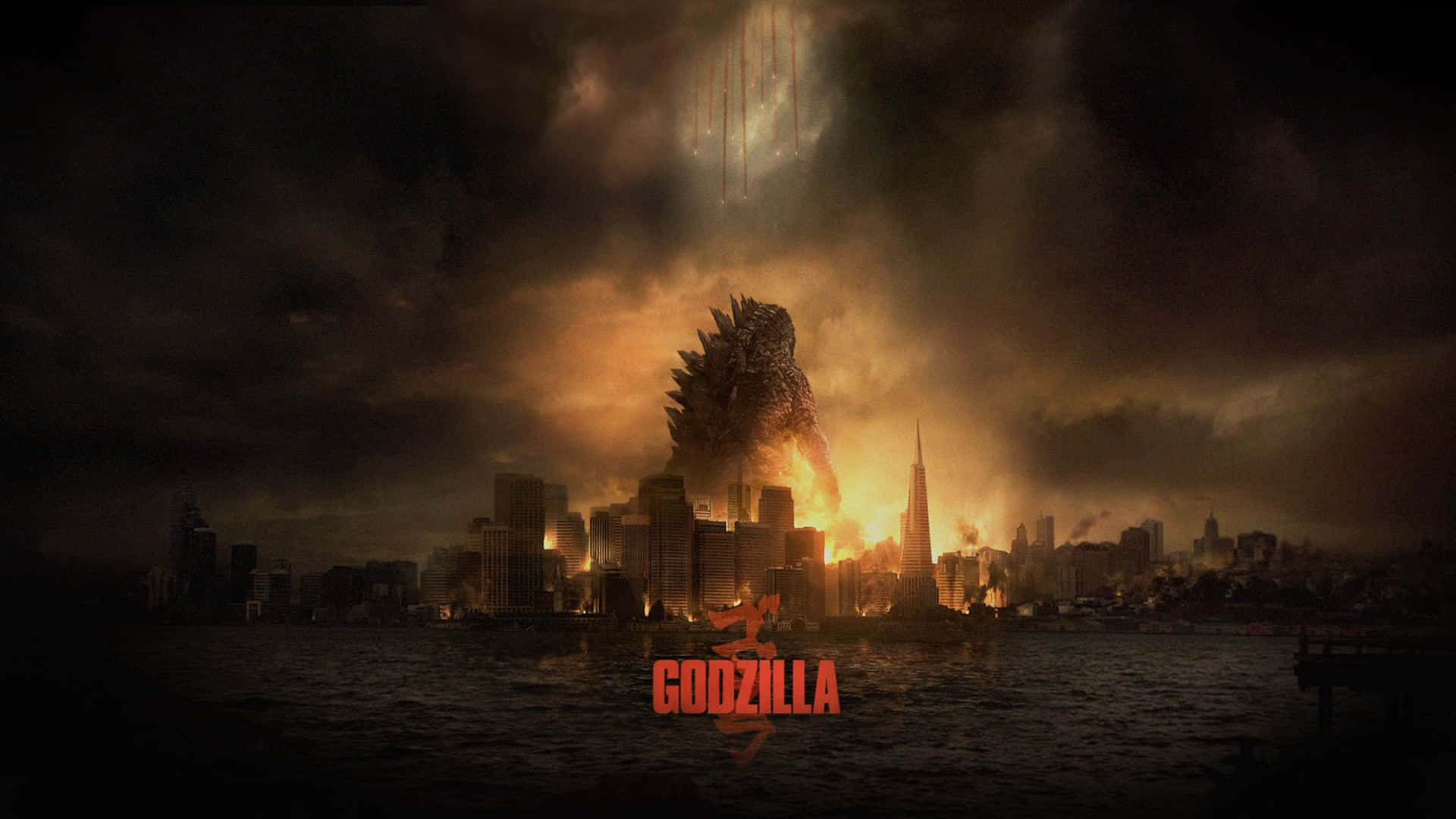 Godzilla City Destruction 桌布 壁紙 — 哥斯拉在黃昏時從燃燒的城市景觀中升起，將熾熱的橙色光芒投射在黑暗的暴風雲上。