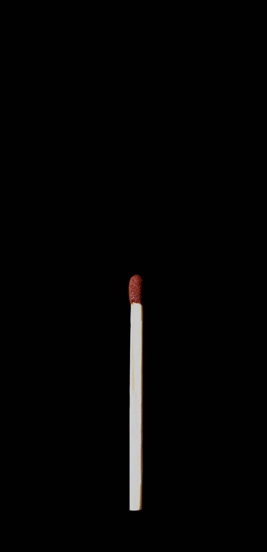 黑色背景上的一根紅色頭火柴