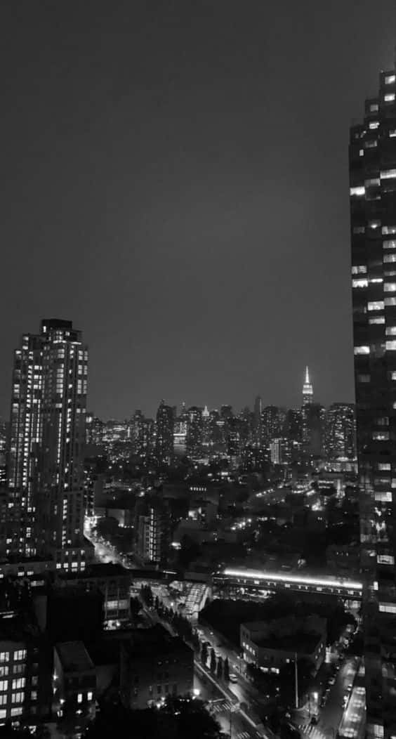 密集城市天際線的黑白夜景，建築物燈火通明。