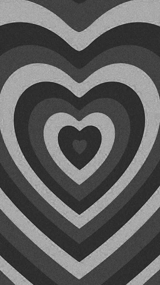 Black And White Heart 桌布 壁紙 — 單色牆紙，以不同灰色深淺的同心心形圖案營造催眠視覺效果。