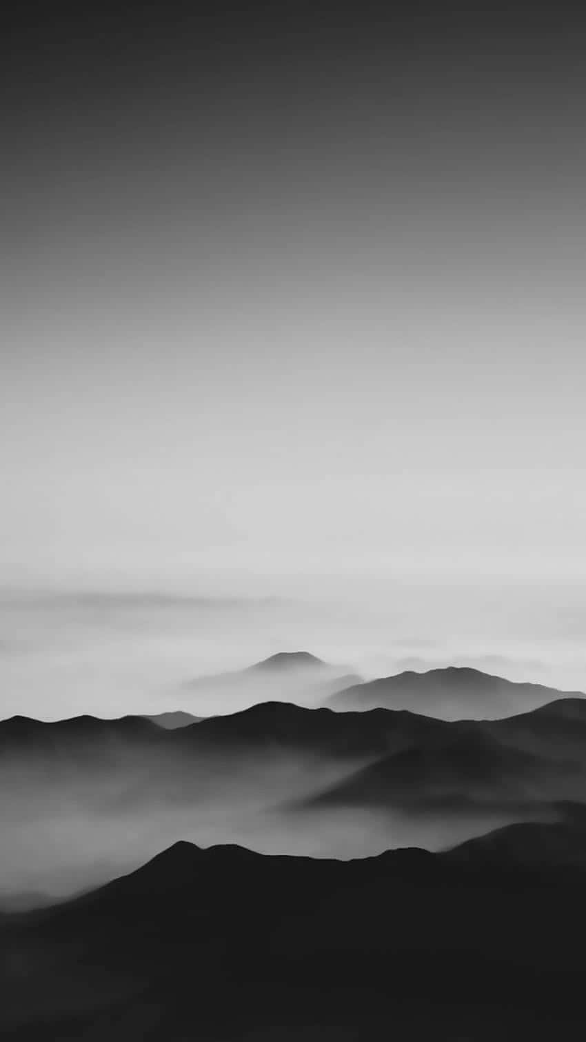 Minimalist Black And White 桌布 壁紙 — 單色霧山融入漸變天空，營造出寧靜的極簡主義景觀。