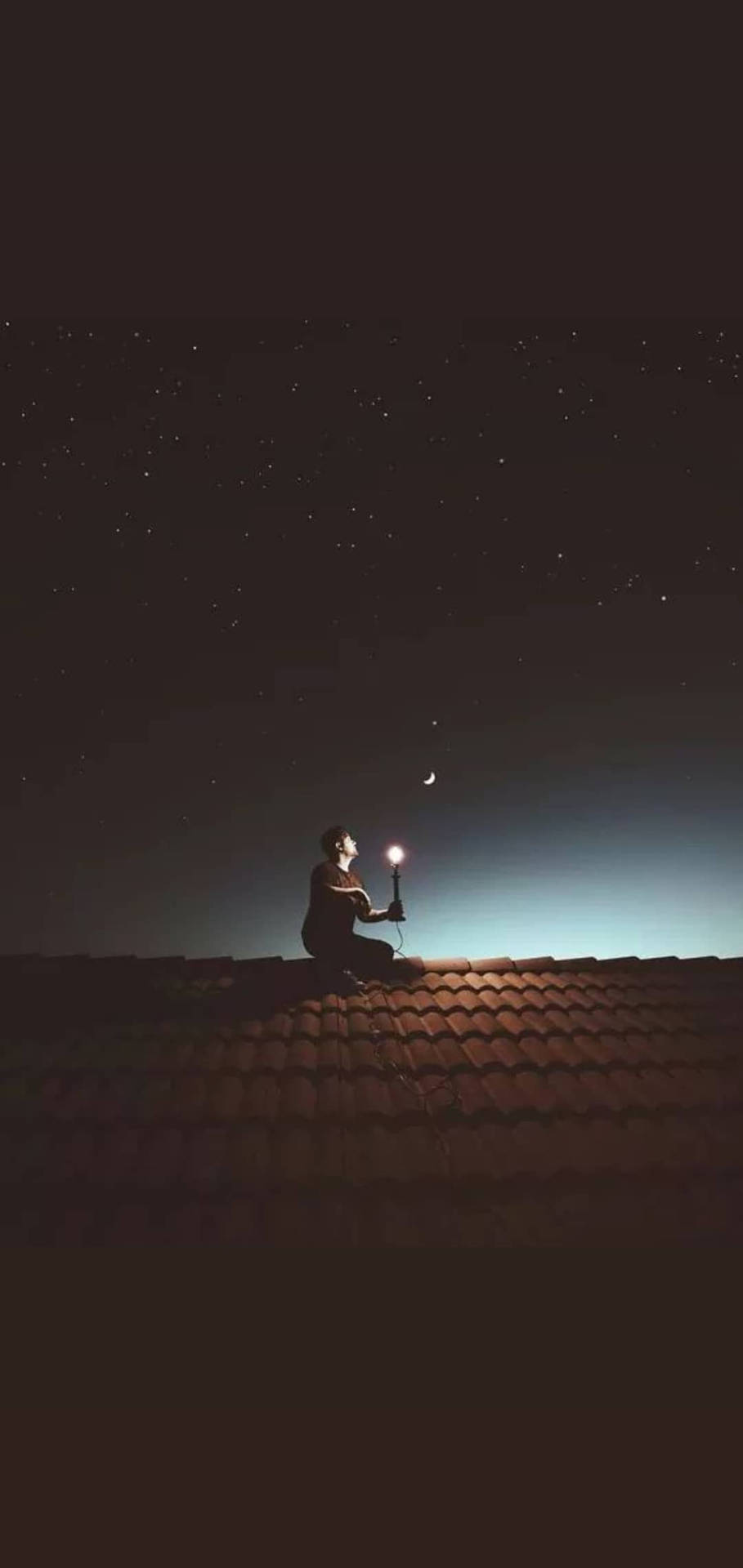 人在屋頂上跪著，在繁星和彎月下舉著燈籠