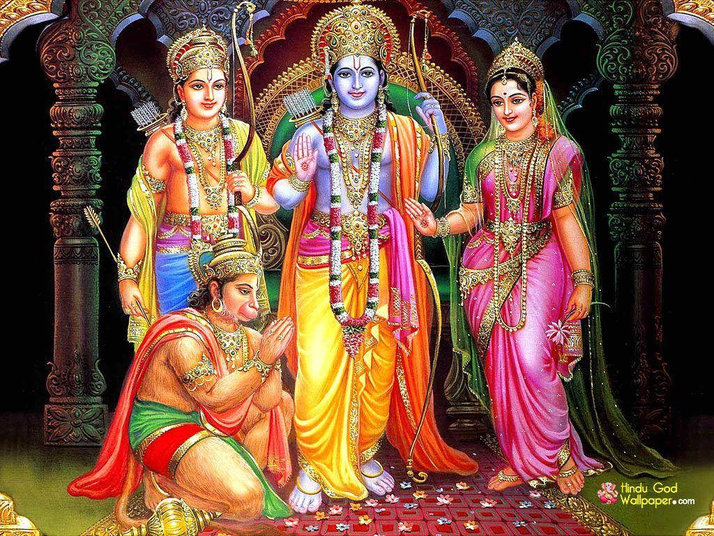 Hindu God 桌布 壁紙 — 四位神聖的印度教人物，佩戴著鮮豔的珠寶和皇家服飾，站在一個雕刻精美的華麗拱門前。