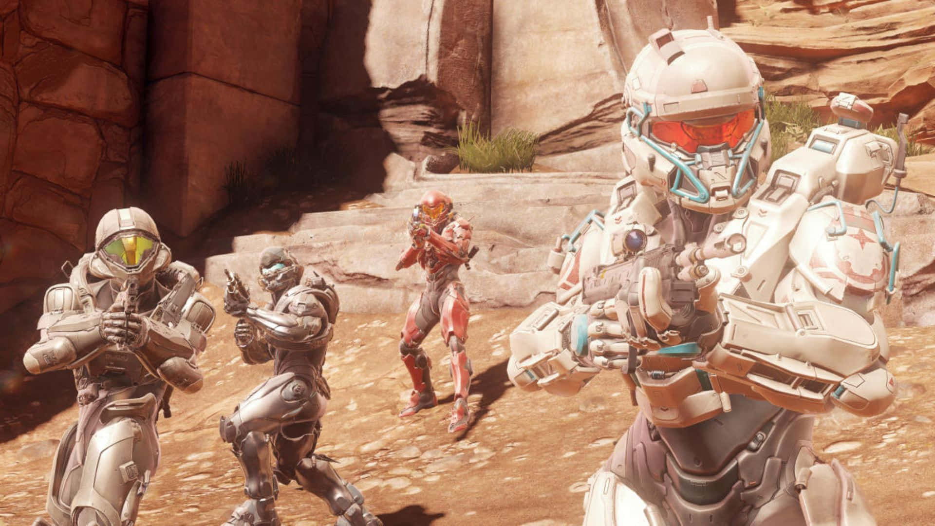 Fireteam Osiris 桌布 壁紙 — 四名身穿未來戰鬥裝備的裝甲士兵在陽光明媚、佈滿沙漠植被的岩石峽谷中保持警覺。