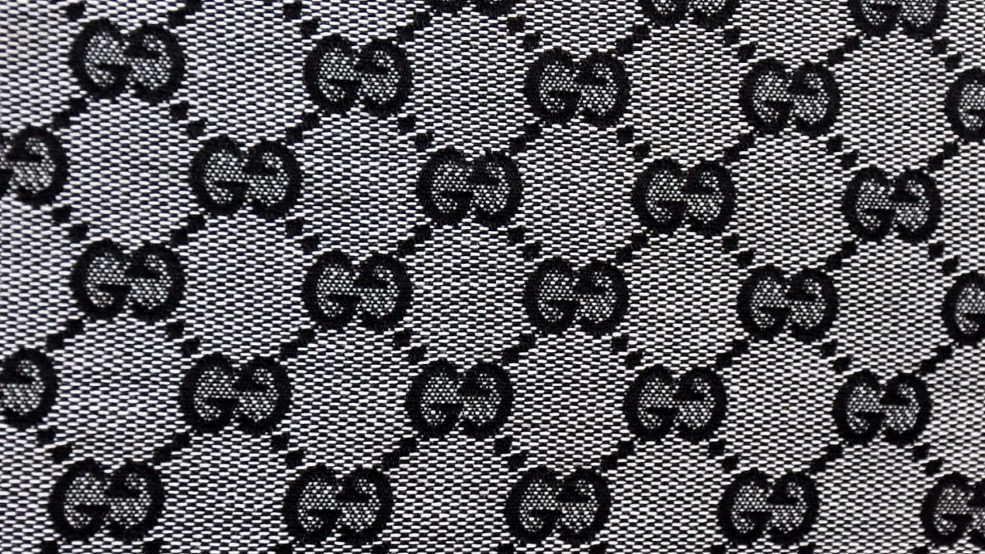 在紋理布料上的黑白Gucci標誌圖案。
