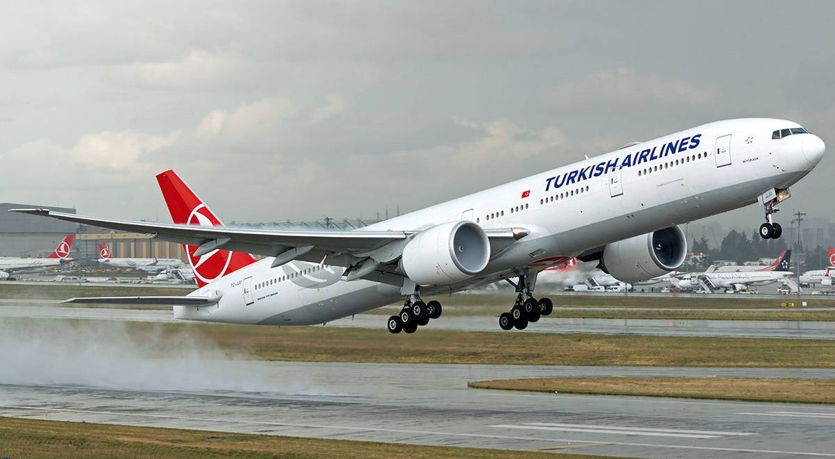 土耳其航空噴射機從濕滑跑道起飛，上空有雲