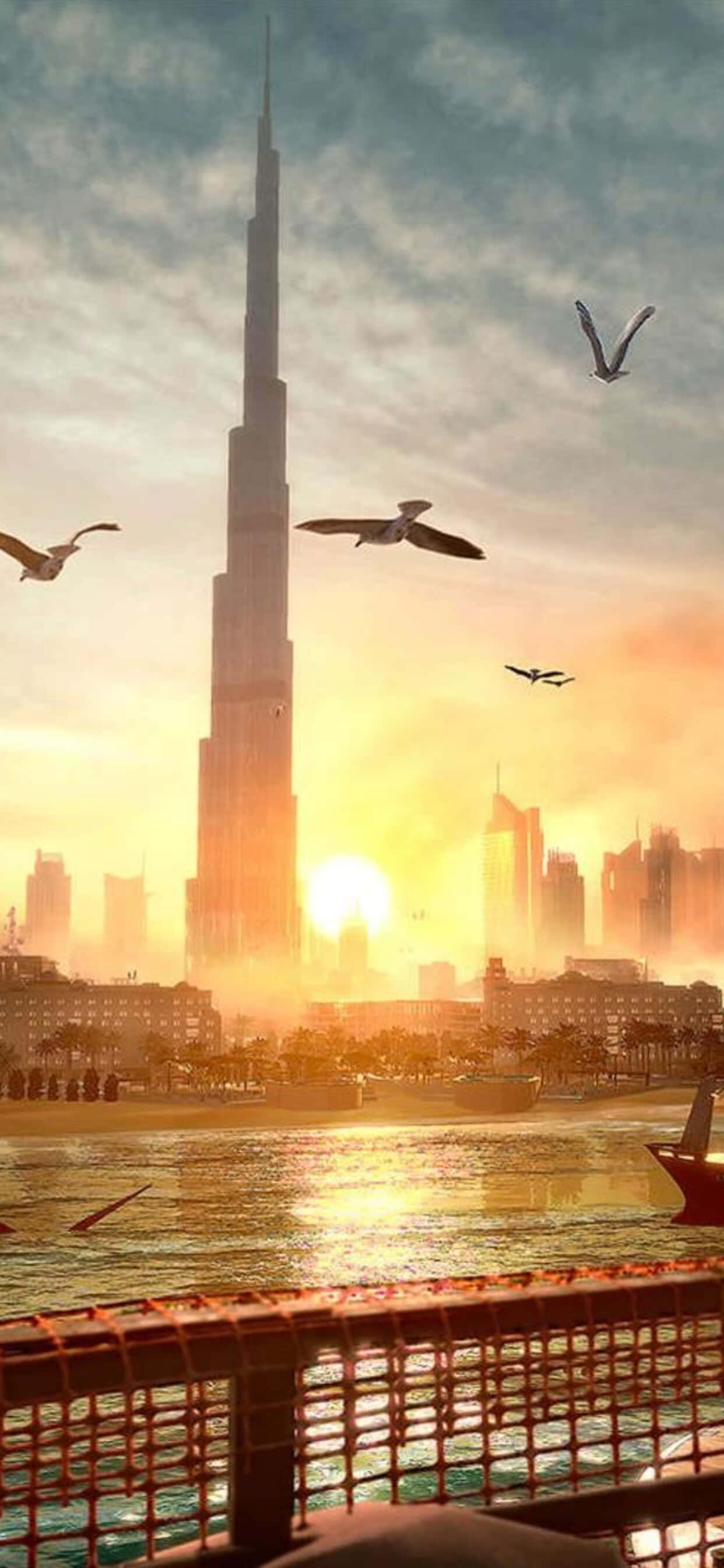 在 Android 平台上體驗《Deus Ex：Mankind Divided》的驚心動魄劇情 壁紙 — 夕陽將哈利法塔和杜拜天際線沐浴在金色光芒中，海鷗在閃爍的海濱上空翱翔。