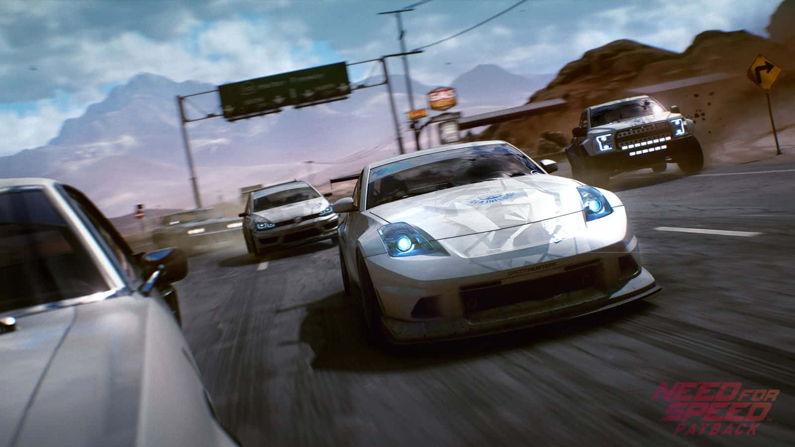 在《Need for Speed Payback》中駕駛穿越文圖拉灣街道 壁紙 — 一輛白色跑車在沙漠公路上飛馳，其他車輛在多雲的天空下揚起灰塵。